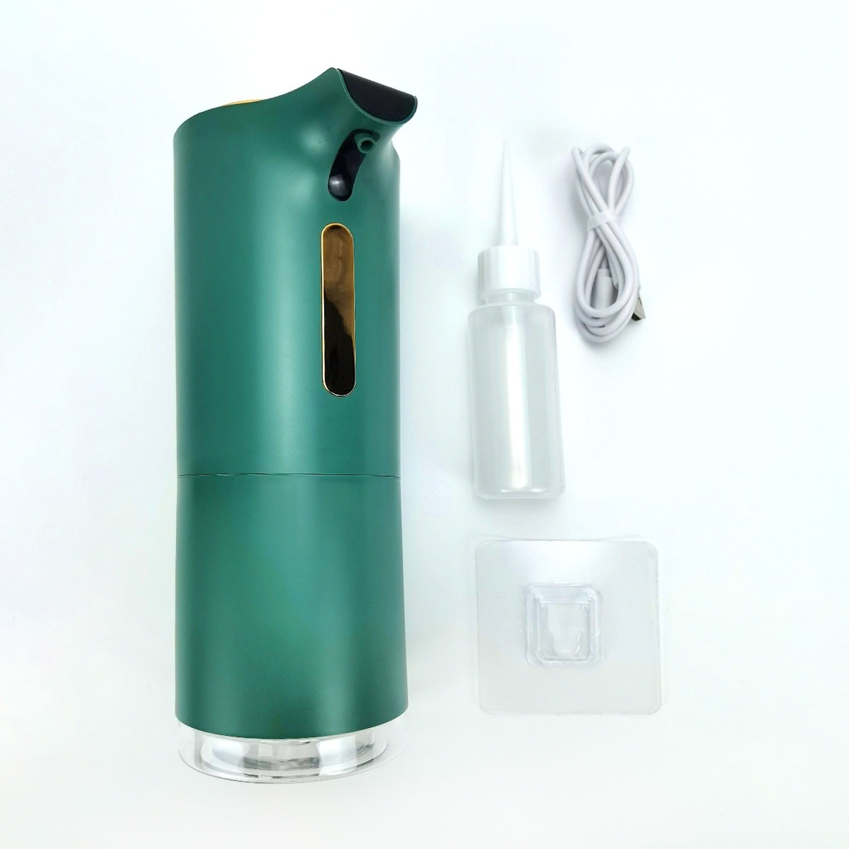 Ein grüner Seifenspender mit einem kleinen transparenten Fläschchen, einem USB-Kabel und einem Klebehaken.