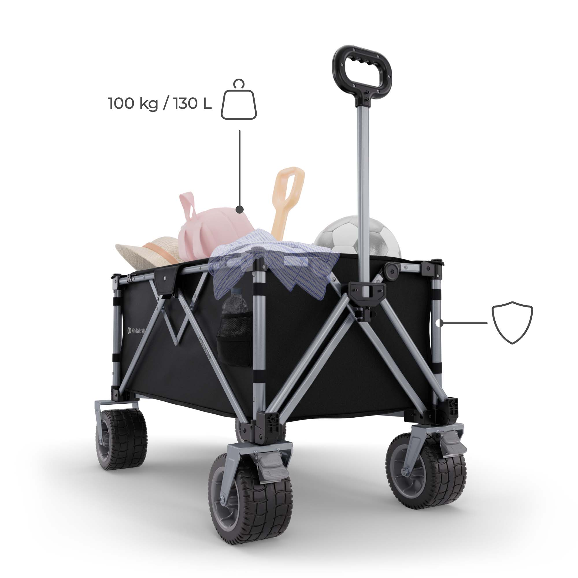 Schwarzer faltbarer Wagen mit Griff, Rädern und Strandartikeln wie Hüten und Ball.