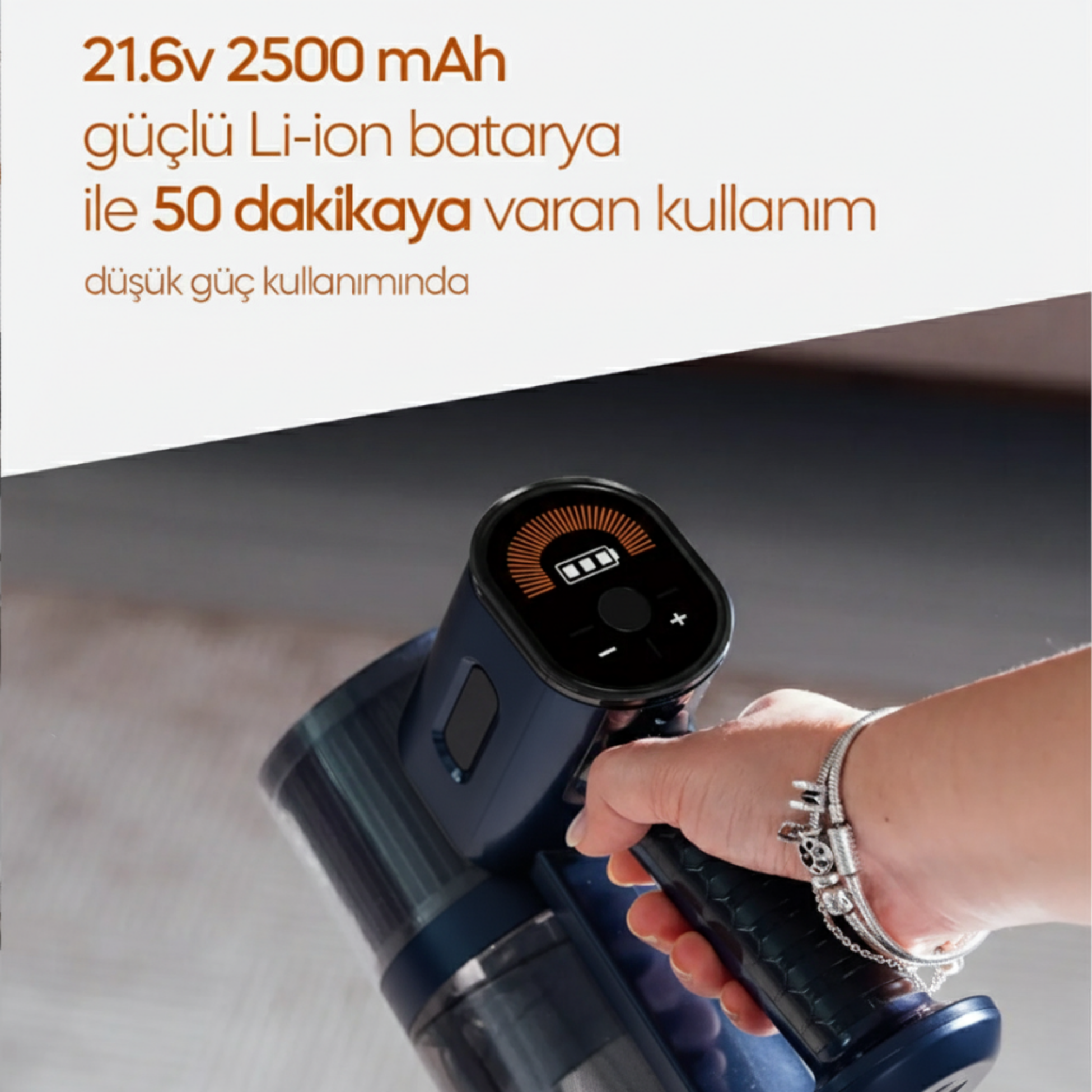 Bir el, dijital ekranlı koyu mavi akülü süpürge tutuyor.