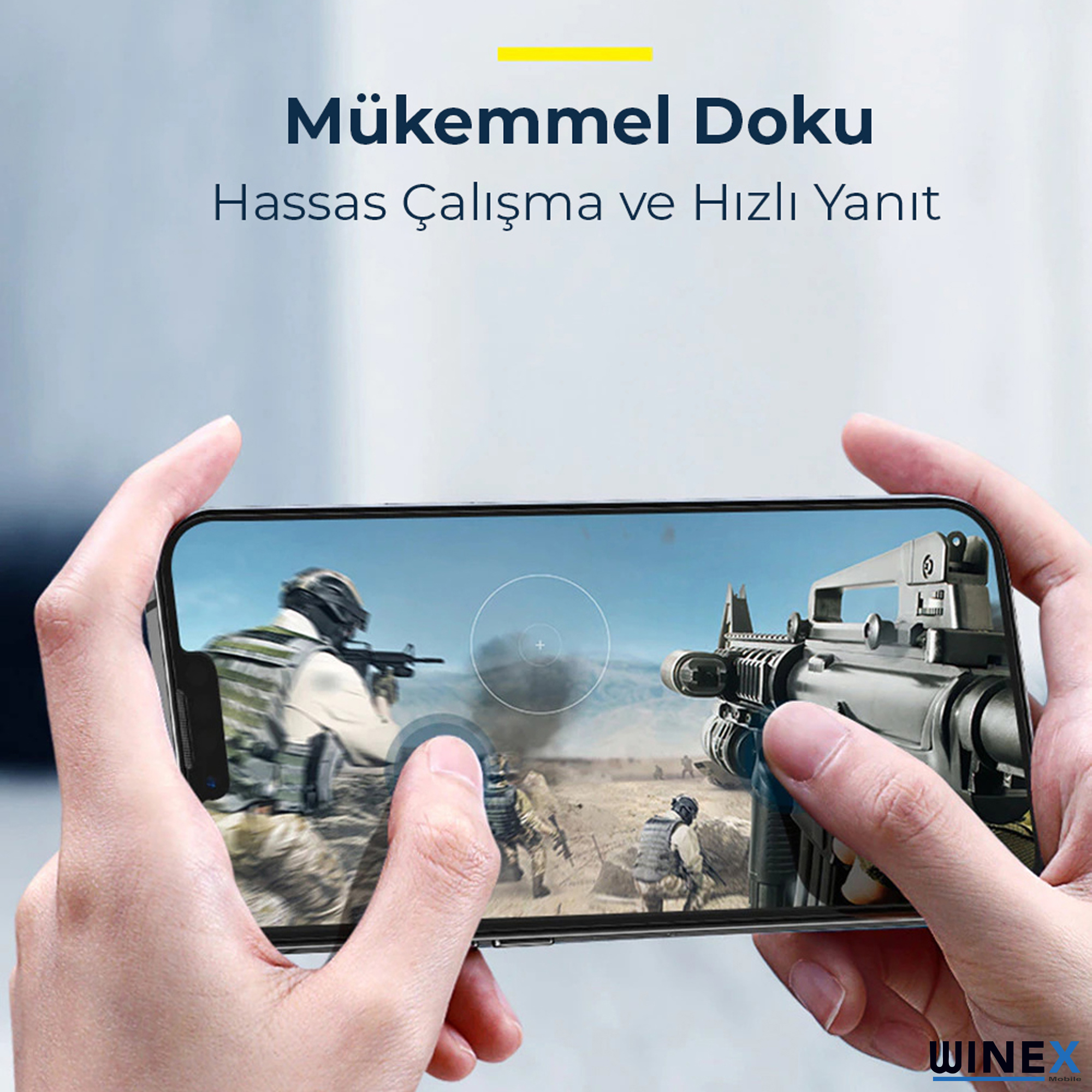Eller, askerler ve silahlar içeren bir aksiyon oyununu gösteren akıllı telefon tutuyor.