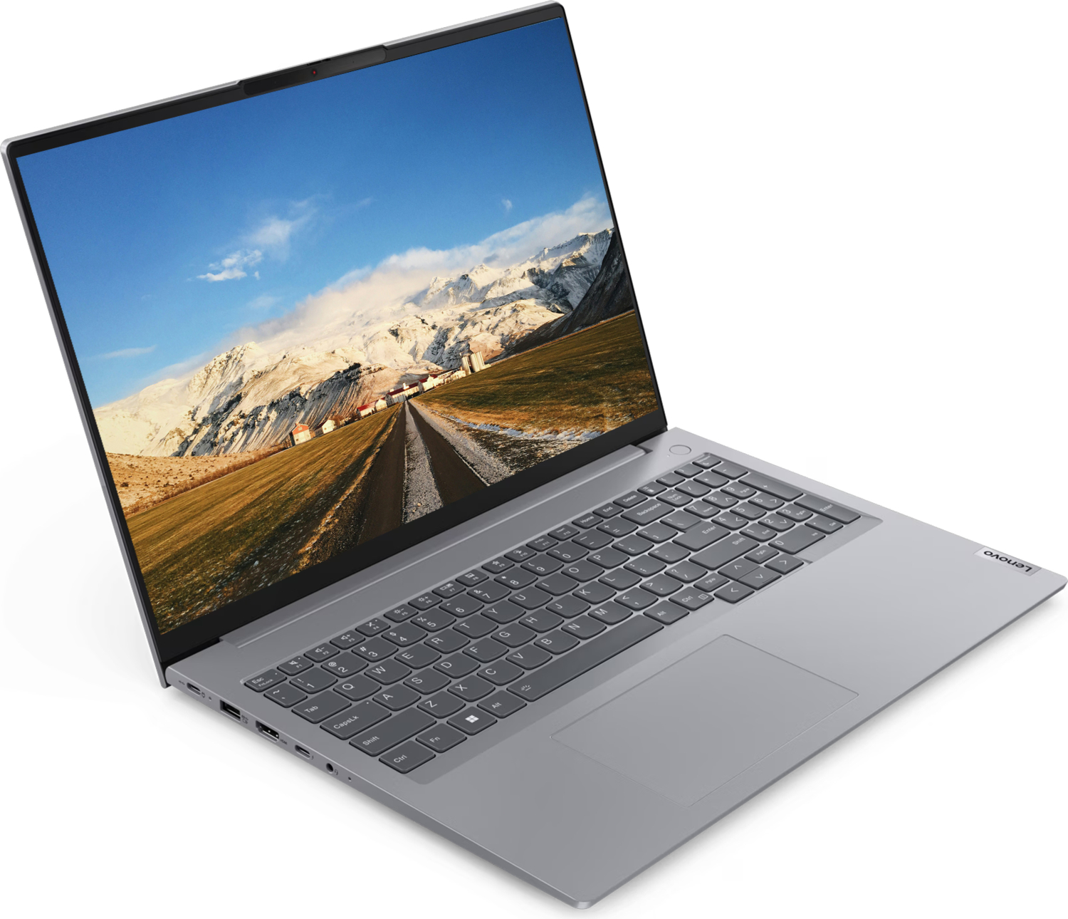 Gümüş renkli Lenovo dizüstü bilgisayar, karlı dağlar ve yolun doğal manzarasını gösteriyor.
