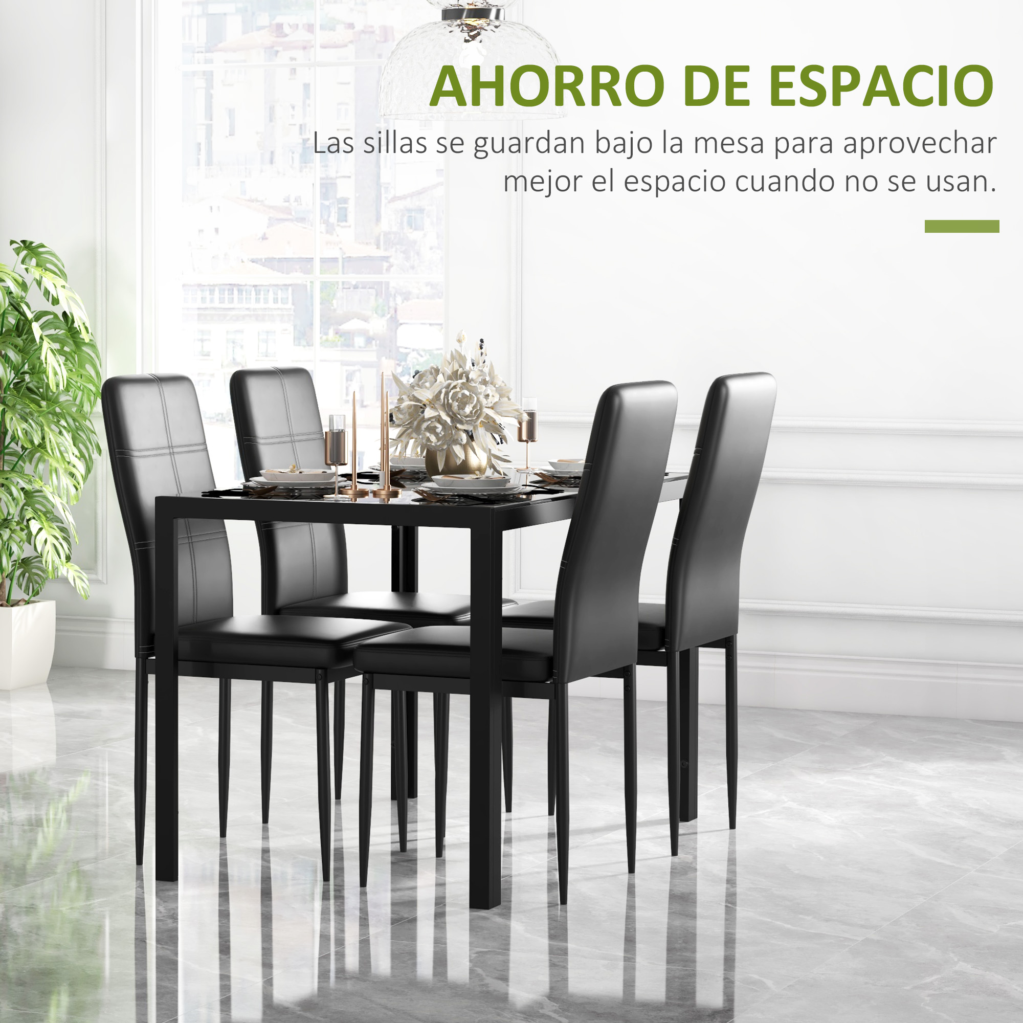 Juego de comedor negro con cuatro sillas y planta en maceta.