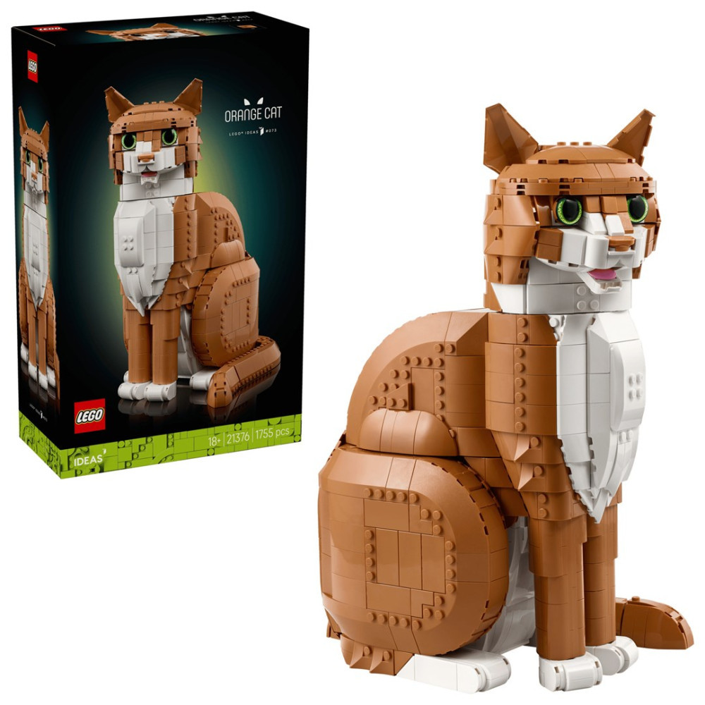 Brązowo-biały kot z klocków Lego siedzi obok pudełka.
