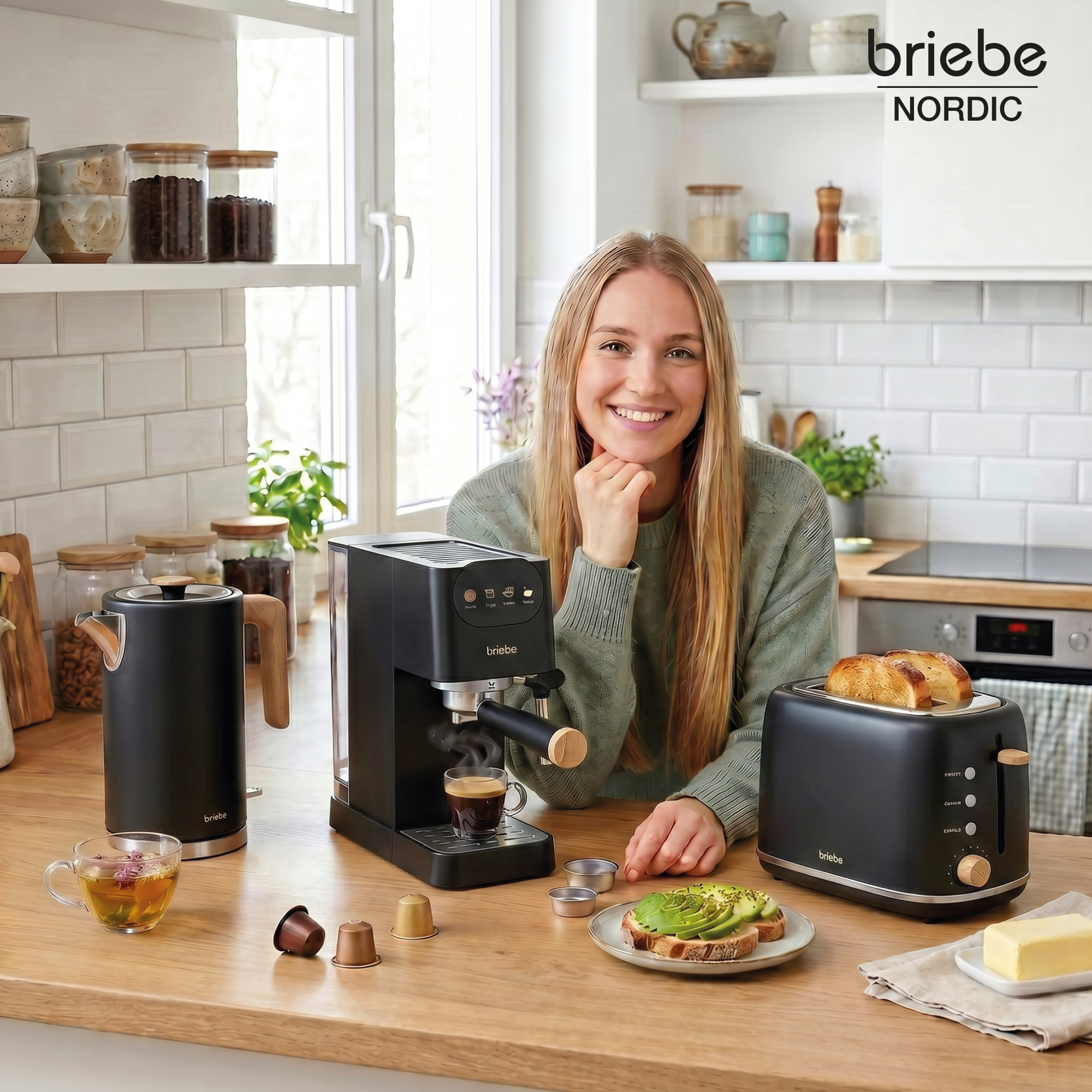 Una mujer sonriendo en una cocina con cafetera, tostadora, tetera y té.