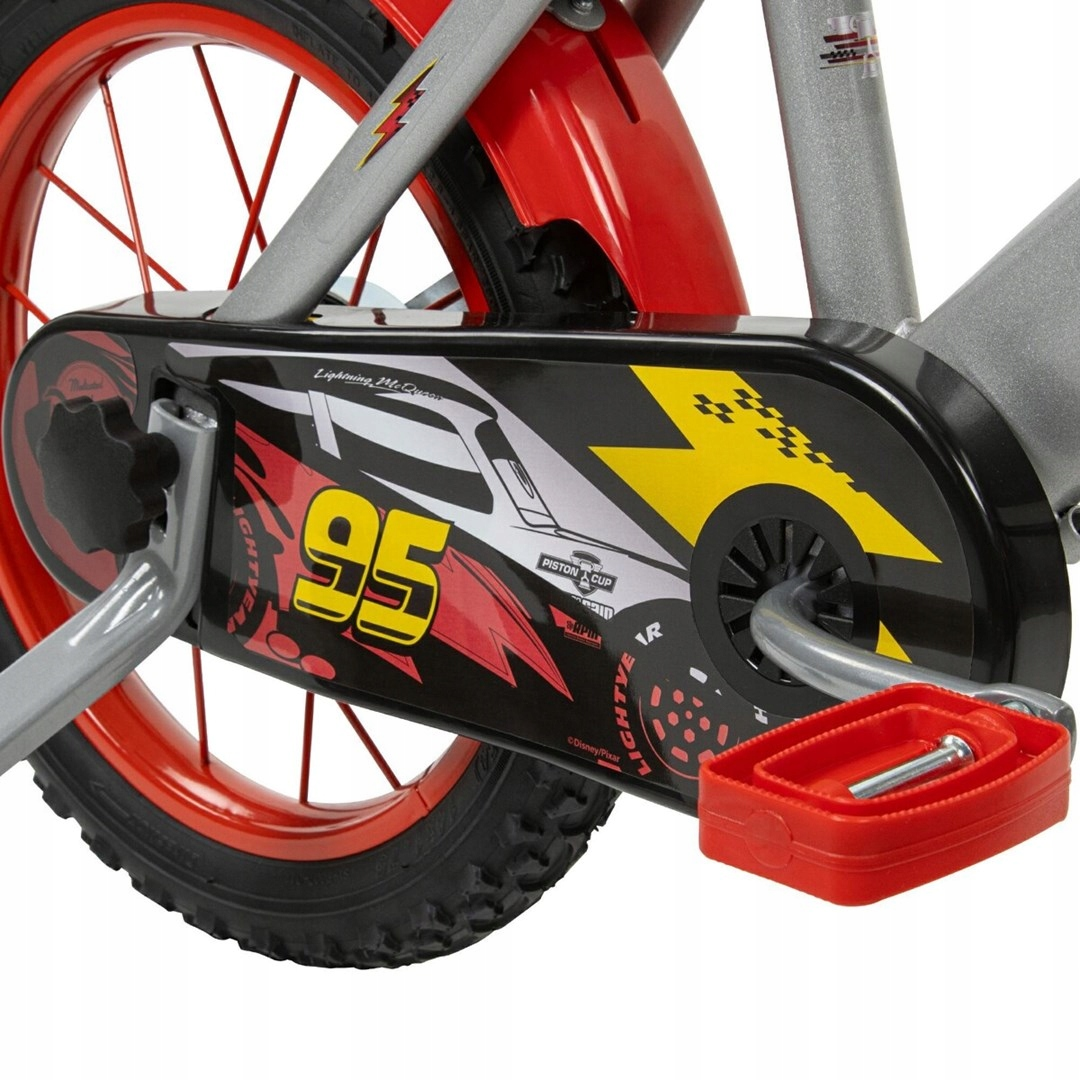 Zbliżenie osłony łańcucha roweru z postacią Lightning McQueen i numerem 95.