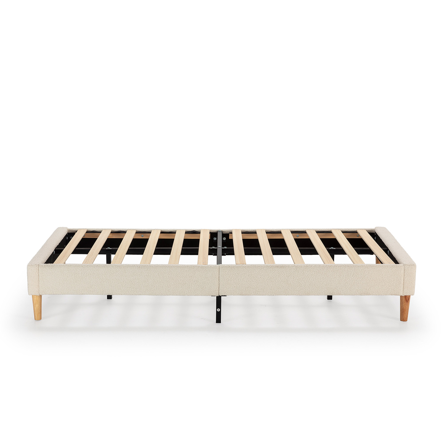 Un somier beige de tela con listones de madera y cuatro patas.