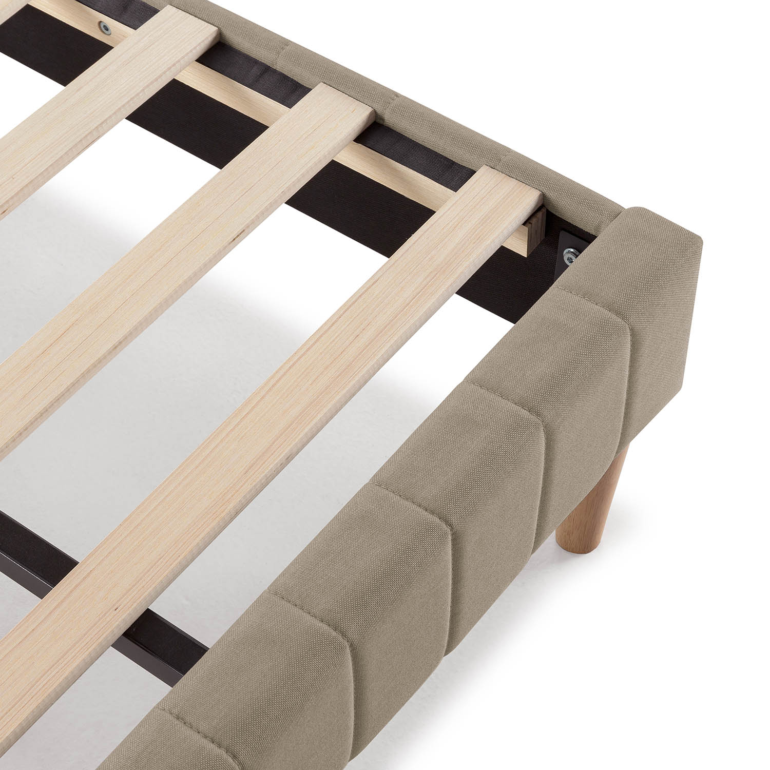 Primer plano de un somier con listones de madera y tela beige.