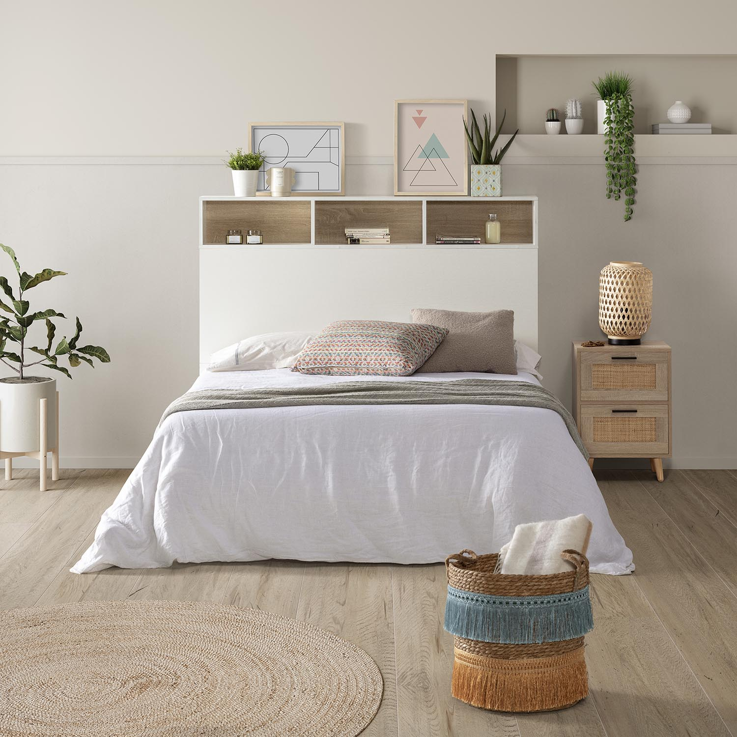 Un dormitorio con cama blanca, mesita de noche, alfombra y cesto.