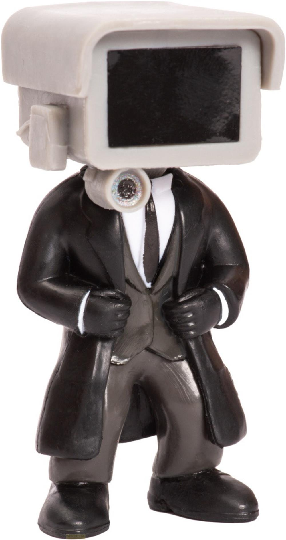 Una figura con testa a forma di telecamera, indossa un abito nero e cravatta.