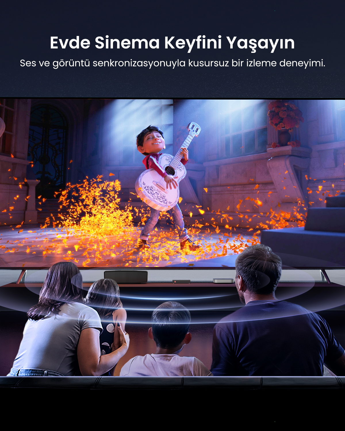 Aile, etrafı turuncu yapraklarla çevrili, gitar çalan bir çocuğun filmini izliyor.