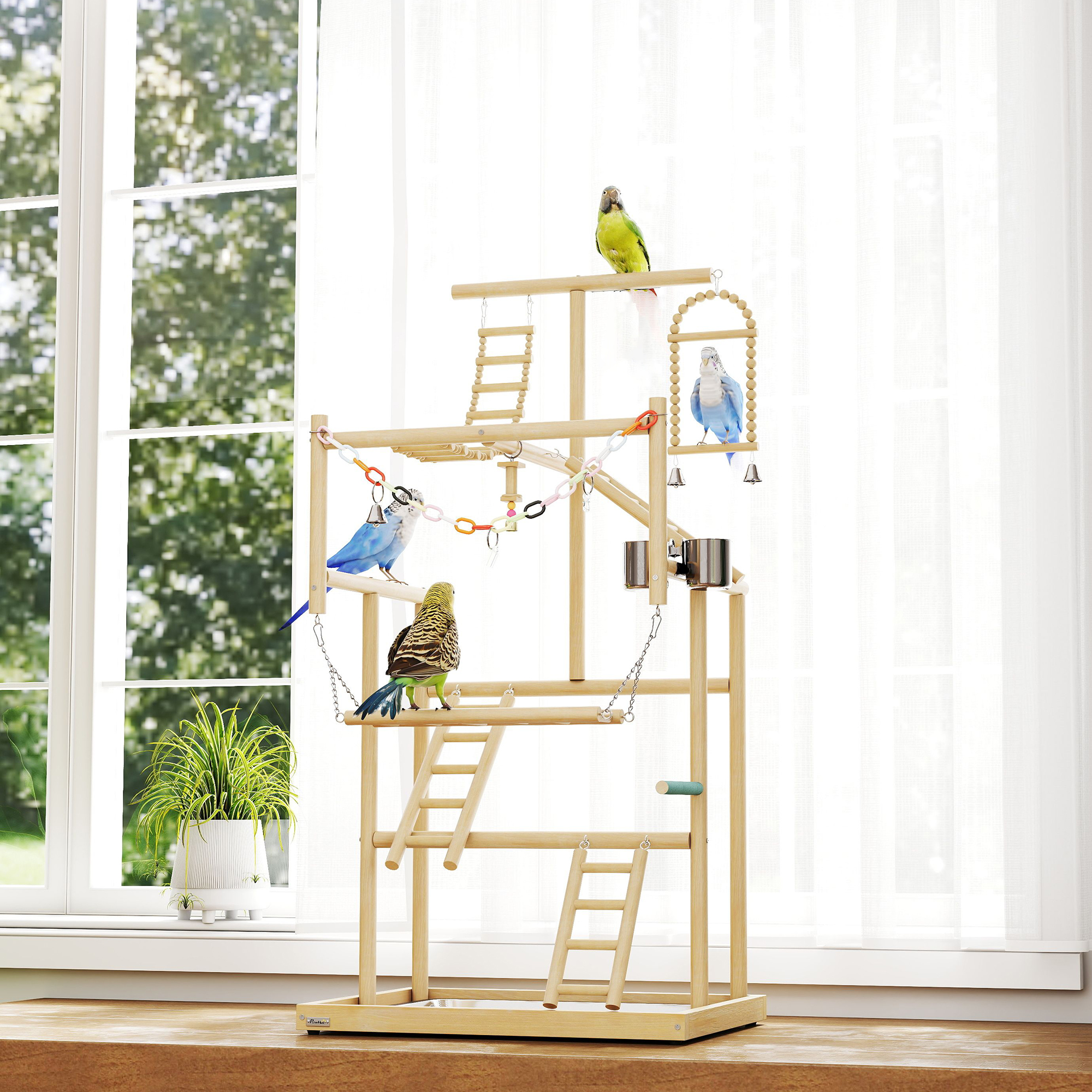 Un parque de juegos de madera para pájaros con cuatro pájaros y juguetes frente a una ventana.