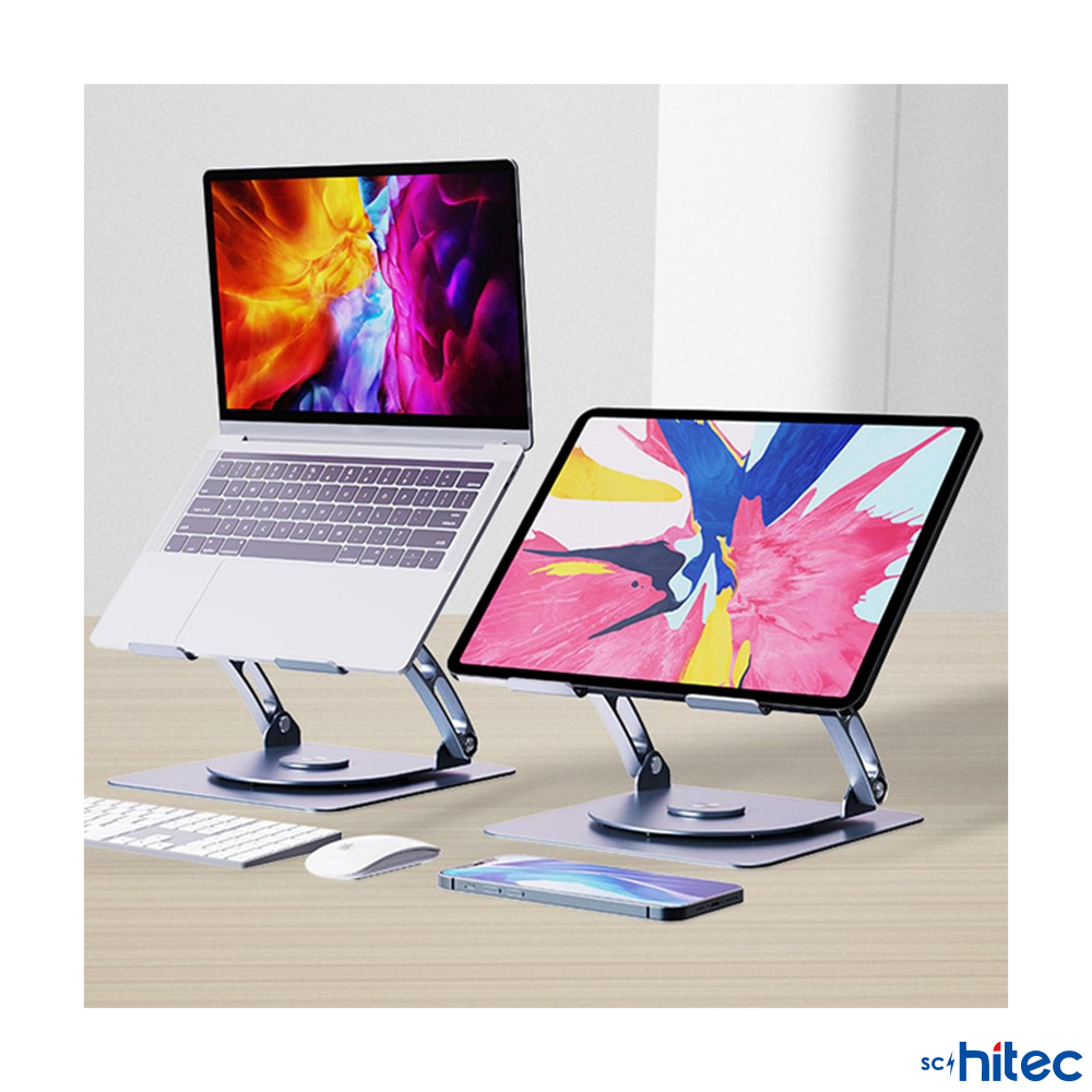 Ayaklıklarda dizüstü bilgisayar ve tablet, yanında klavye, fare ve telefon.