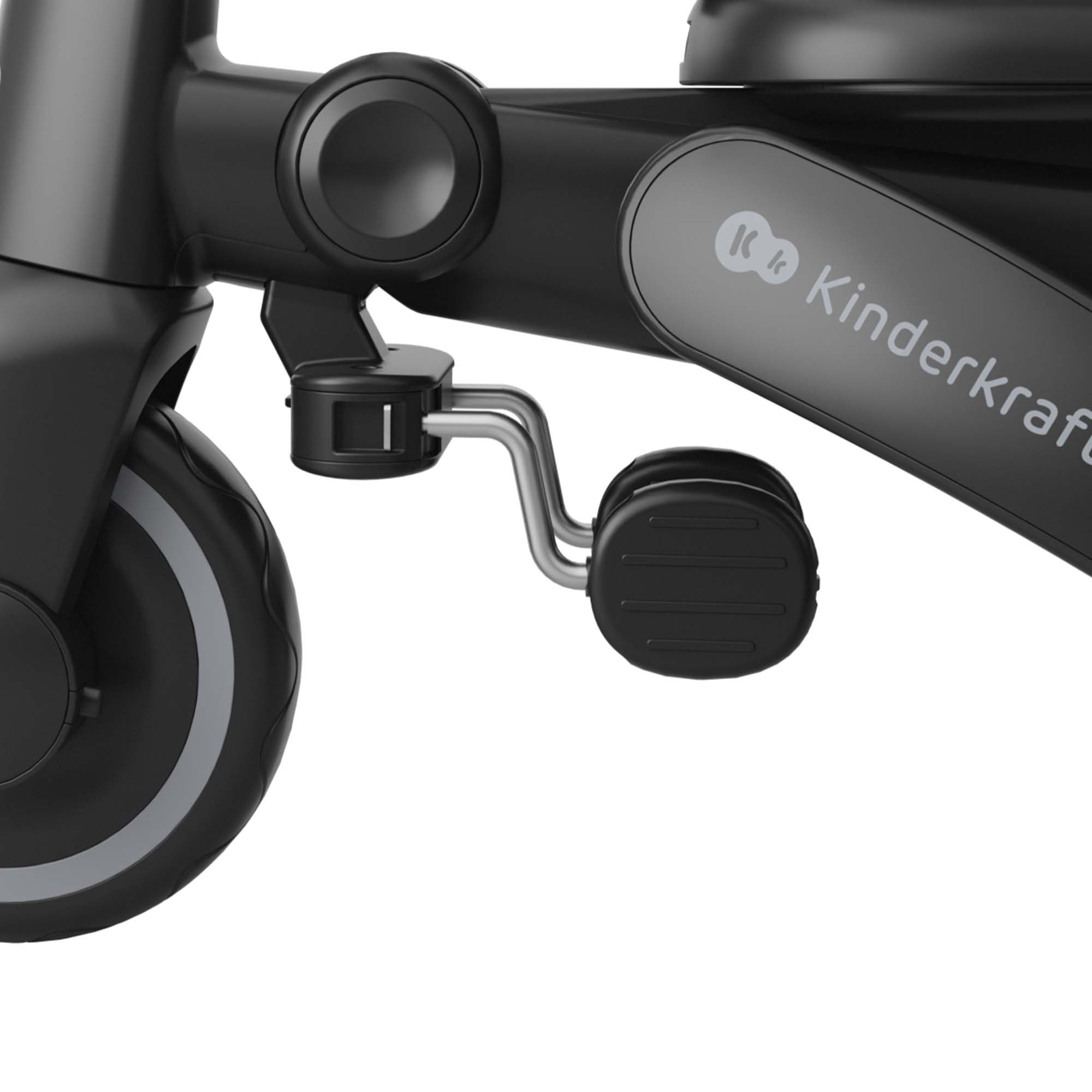 Primer plano de un triciclo negro Kinderkraft mostrando el pedal y la rueda.