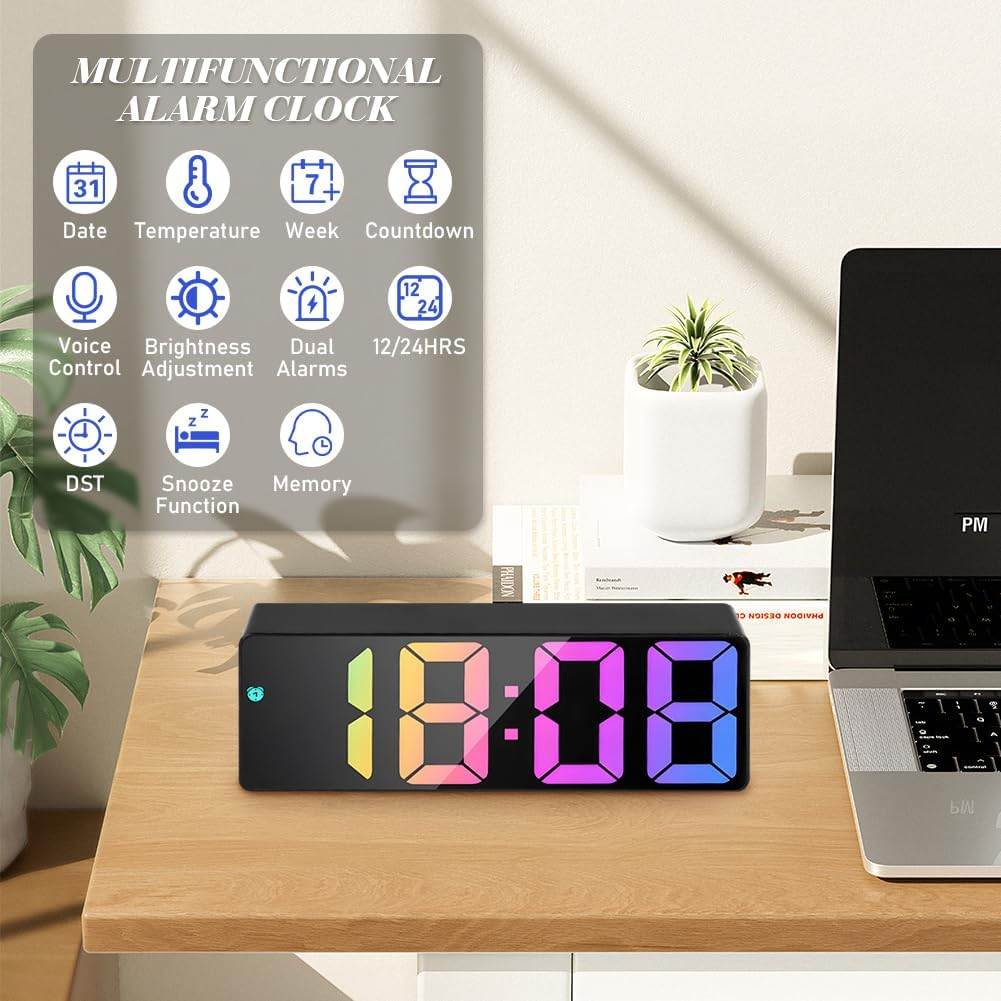 Digitaler Wecker zeigt 18:08 mit regenbogenfarbenen Ziffern auf einem Holzschreibtisch.