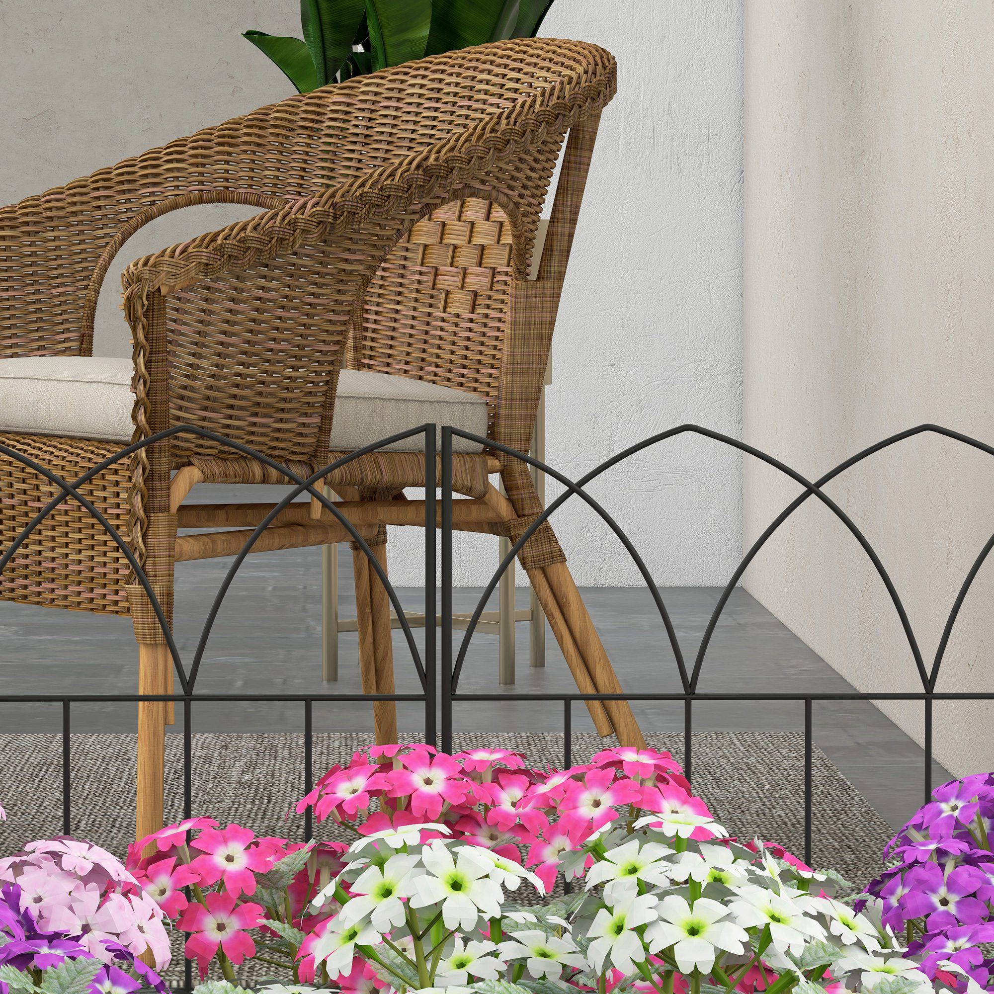 Una silla de mimbre con cojines junto a flores coloridas.