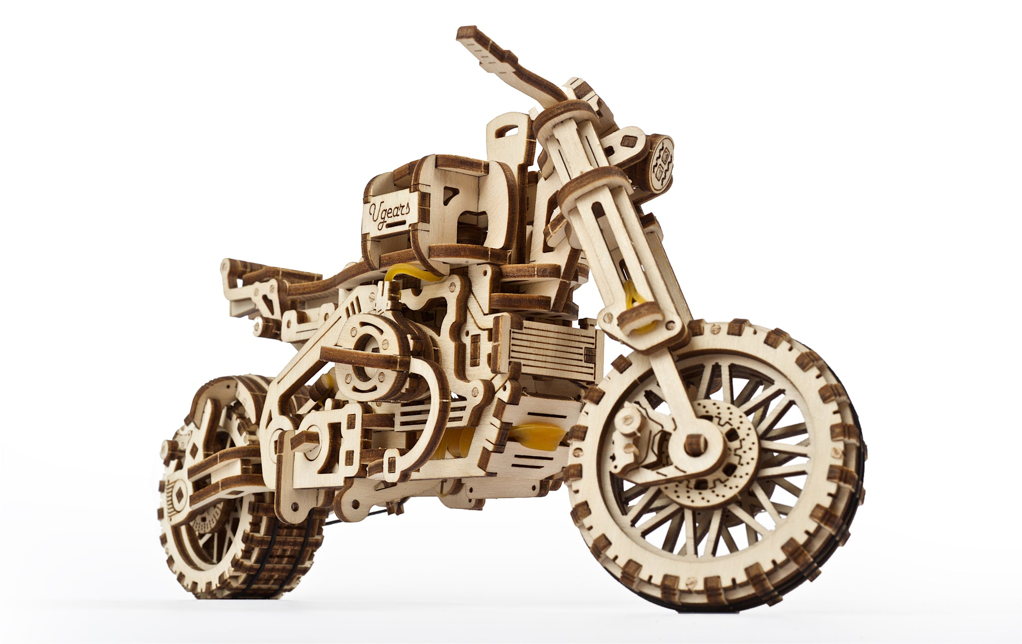 Drewniany model motocykla z widocznymi zębatkami i gumkami.