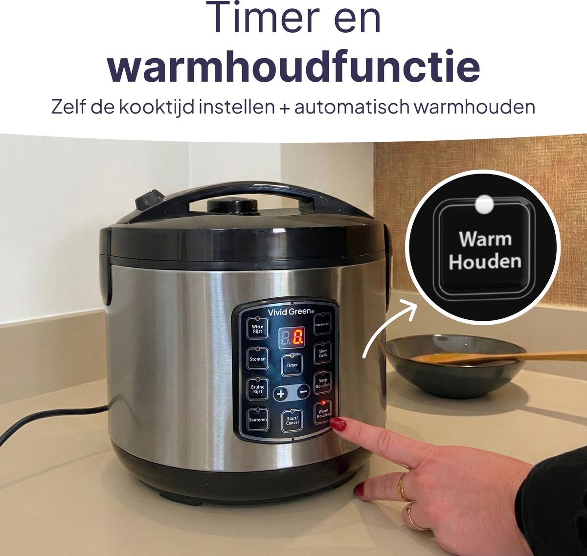 A silver rice cooker with control panel, a hand presses the keep warm button.