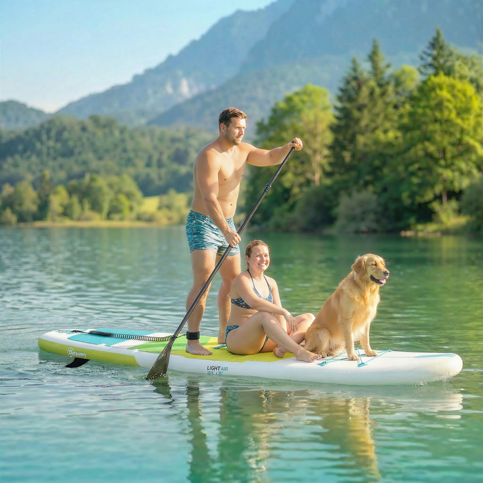 Hombre, mujer y perro en una tabla de paddle surf en un lago con montañas.