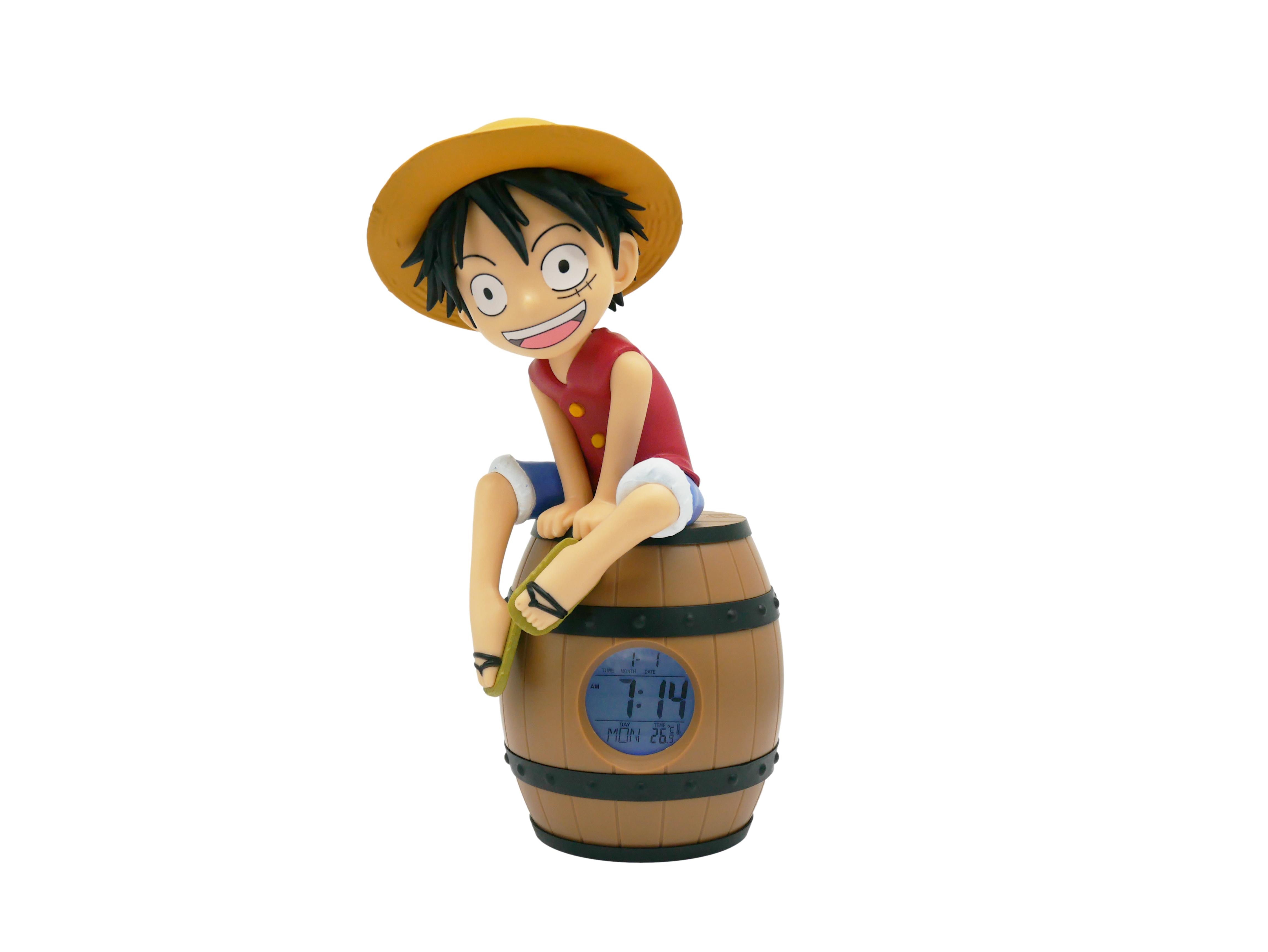 Eine Figur von Luffy sitzt auf einem hölzernen Fass-Wecker. Er trägt einen Strohhut und rote Weste.