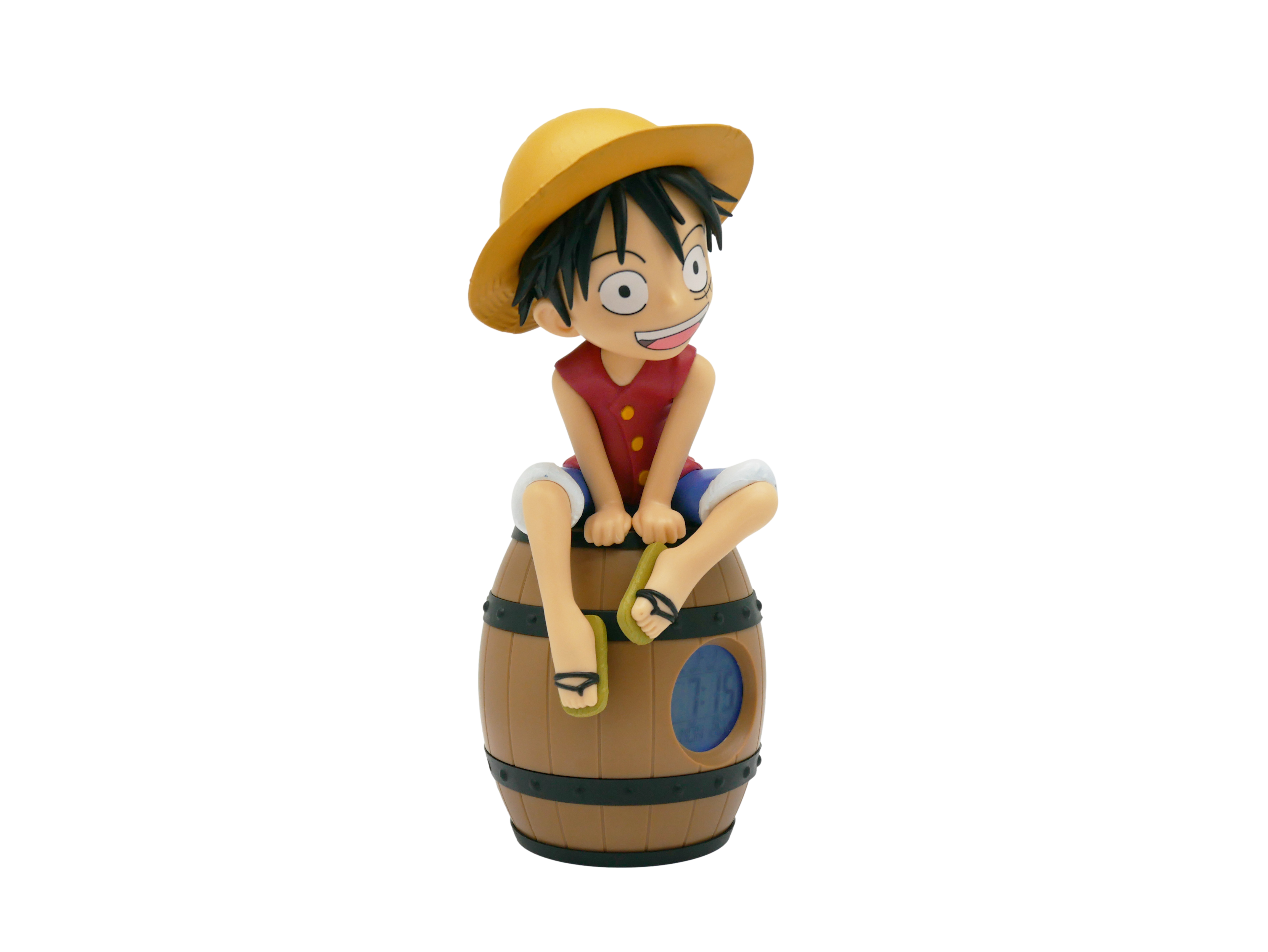 Eine Figur sitzt auf einem Fass mit einem digitalen Wecker.