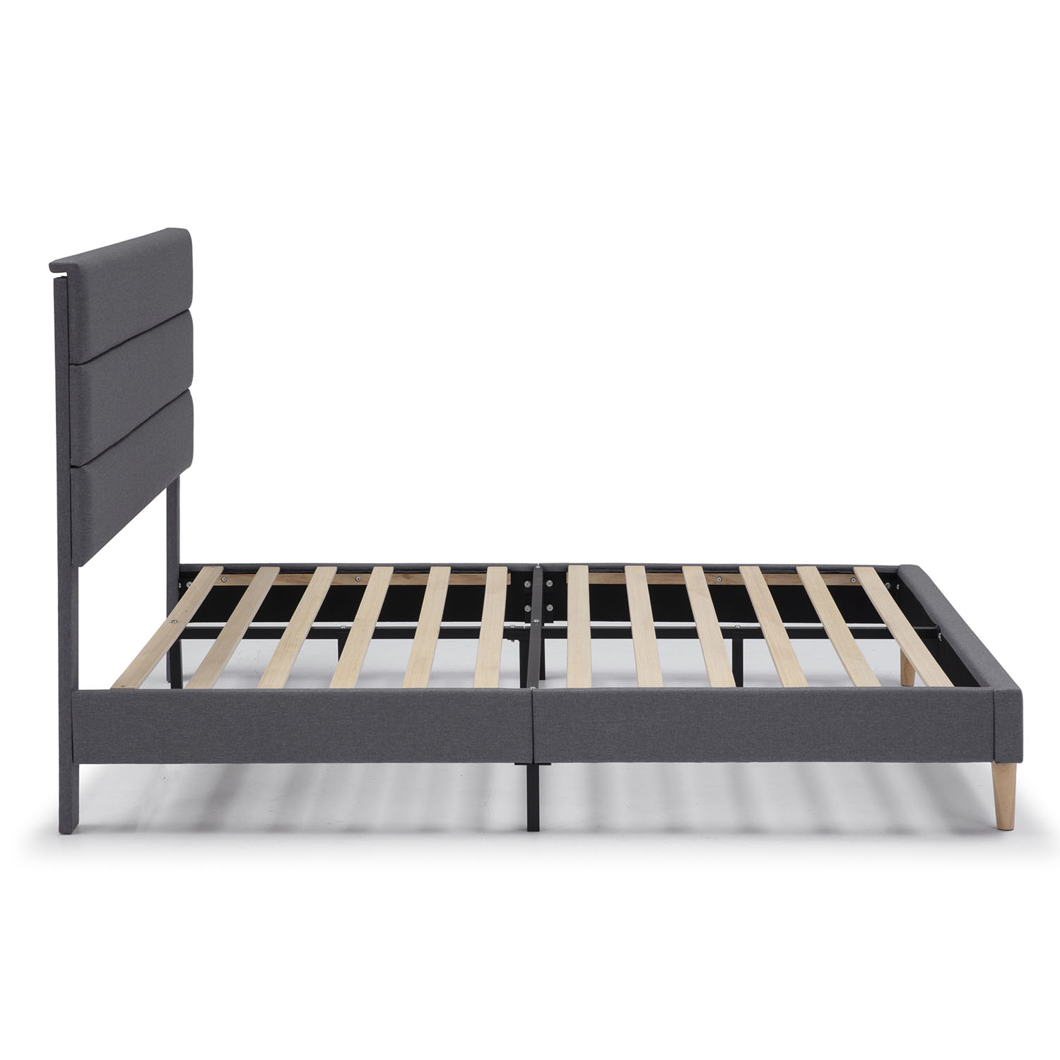 Un somier gris con cabecero acolchado y listones de madera.
