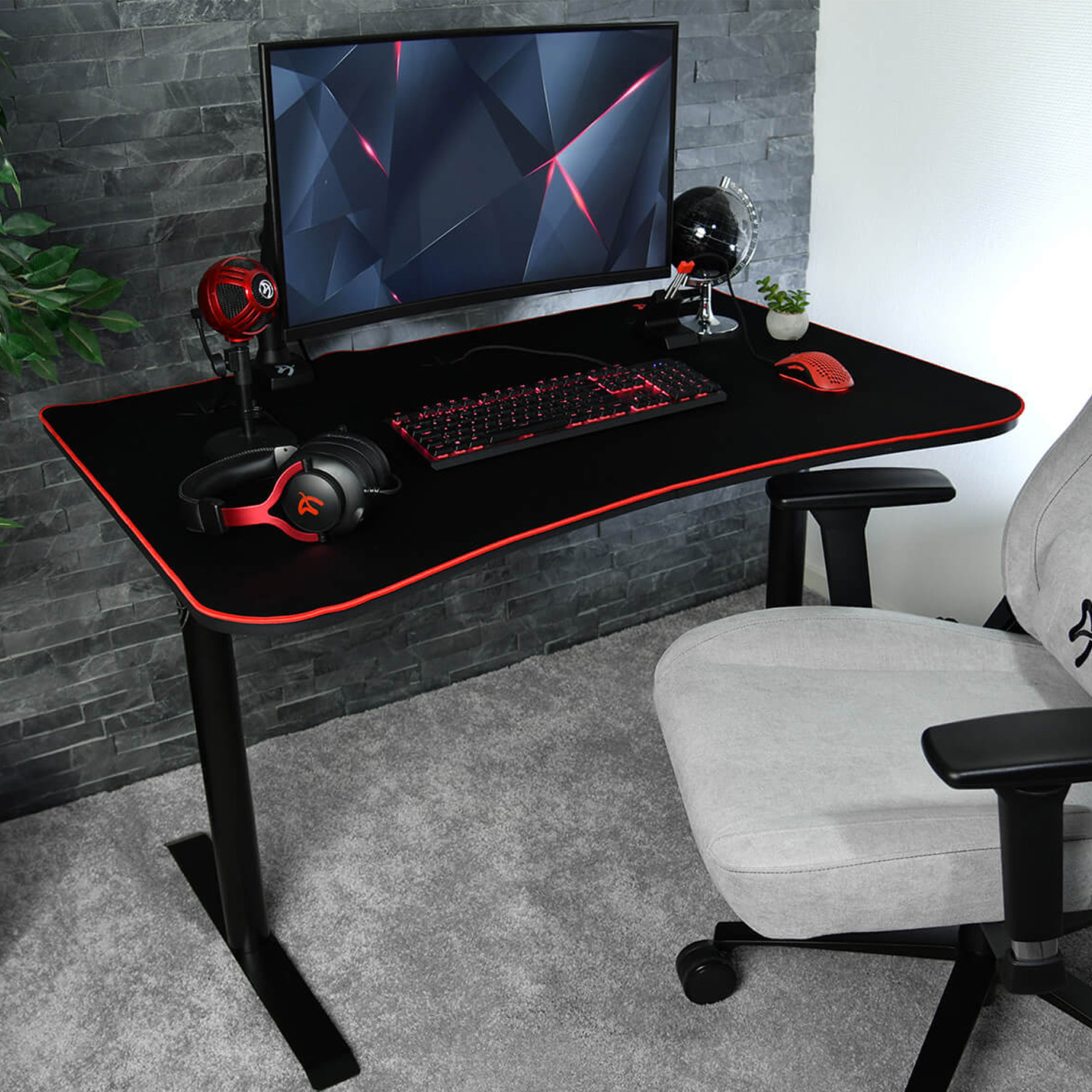 Una postazione da gaming con monitor, tastiera, mouse, cuffie e microfono.