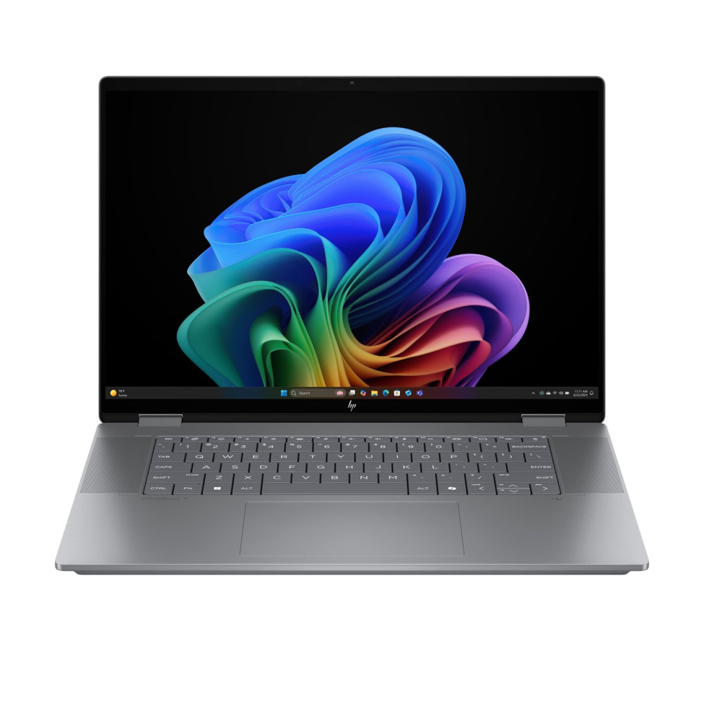 Otwarty laptop wyświetlający kolorową abstrakcyjną tapetę na ekranie.