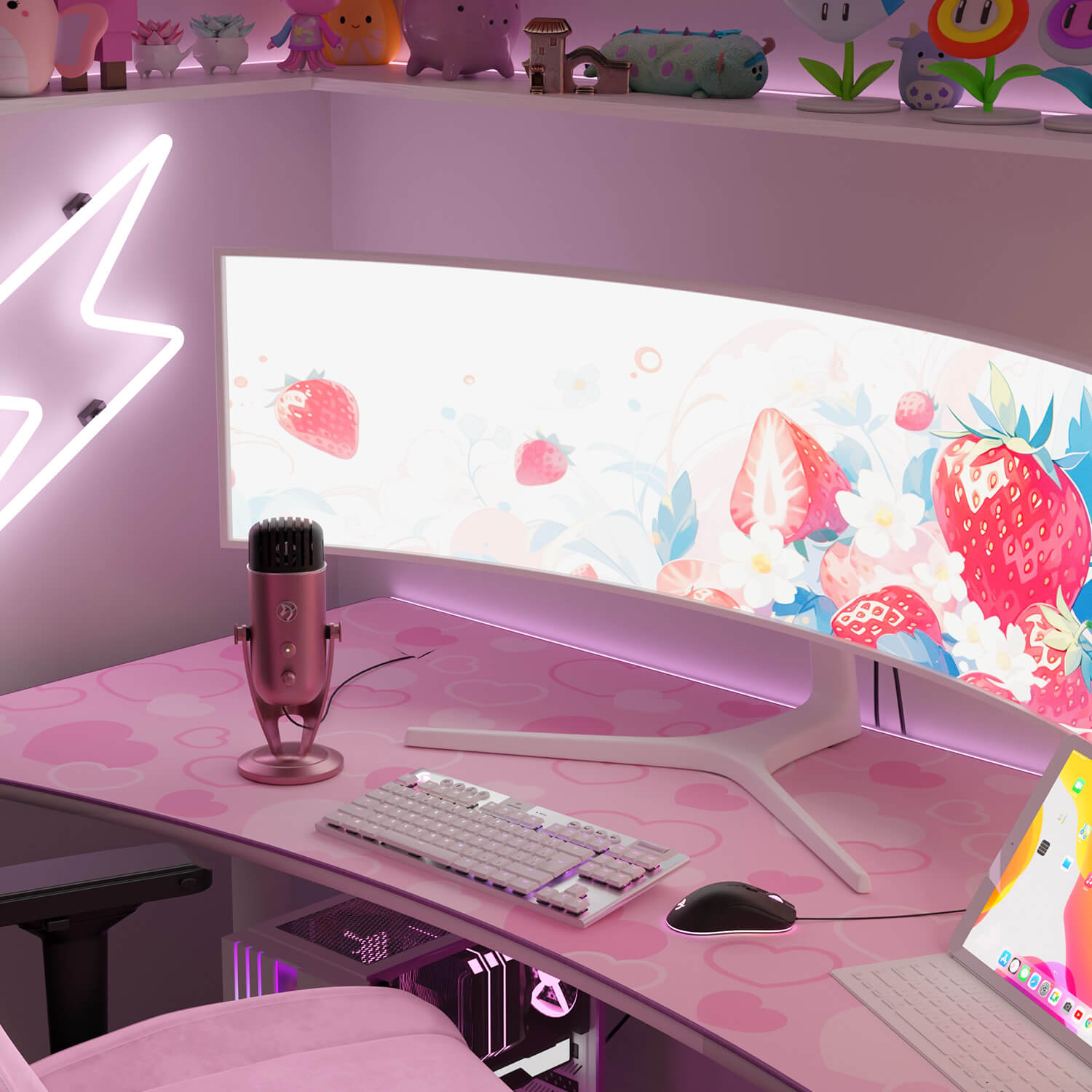 A pink gaming desk with a strawberry theme, featuring a curved monitor, keyboard, mouse, and mic.