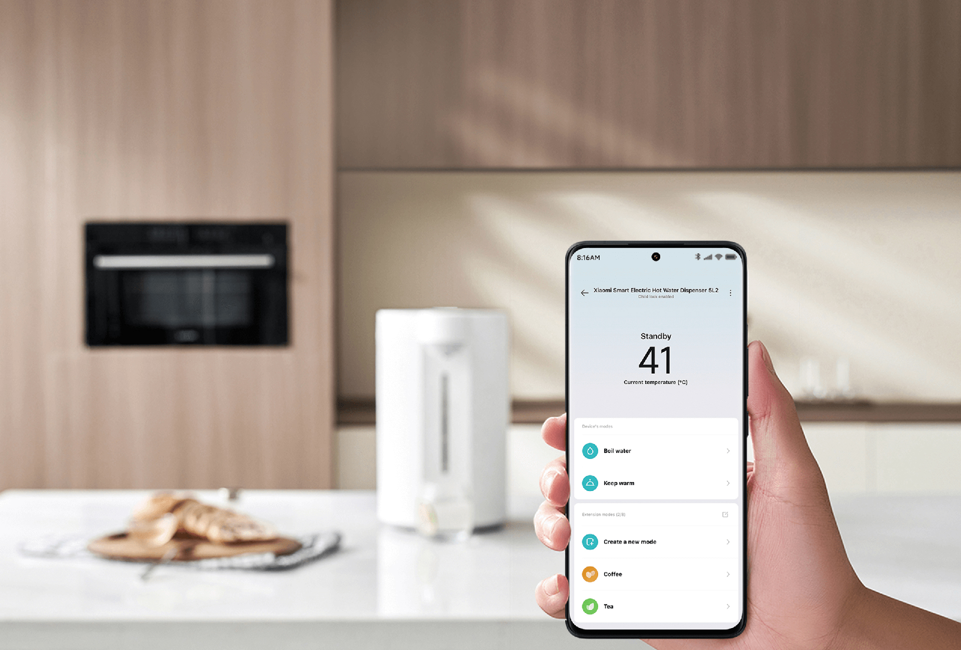 A phone shows a water dispenser control at 41°C. An oven and bread are in the background.