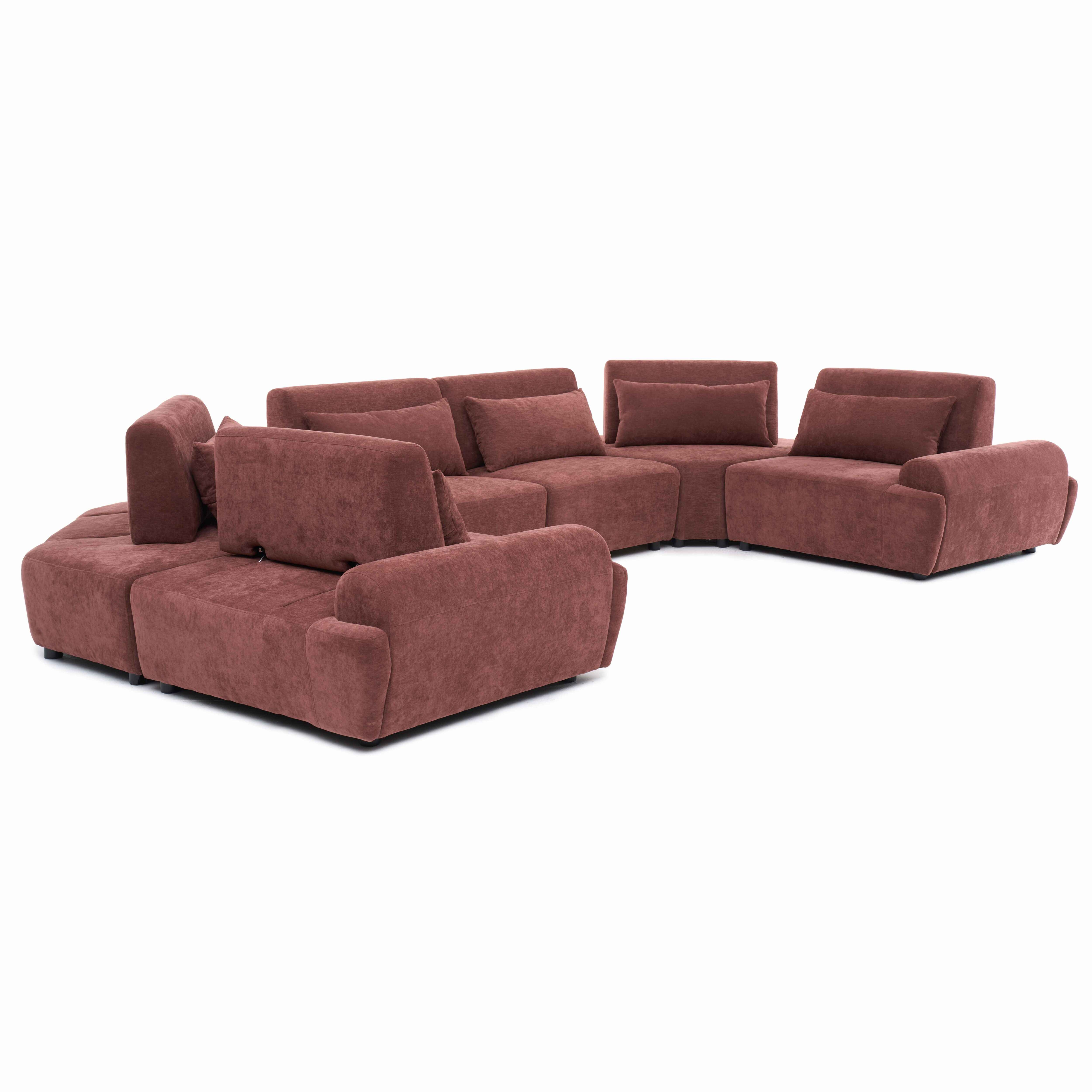 Ein rosafarbener Ecksofa-Modul mit Kissen auf weißem Hintergrund.