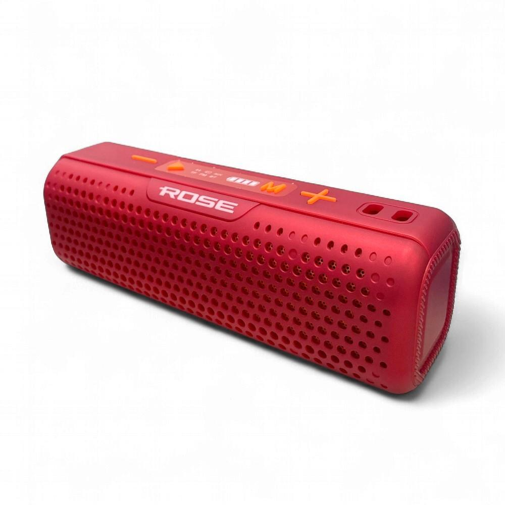 Delikli ön ve üst kontrol düğmelerine sahip kırmızı bir Bluetooth hoparlör.