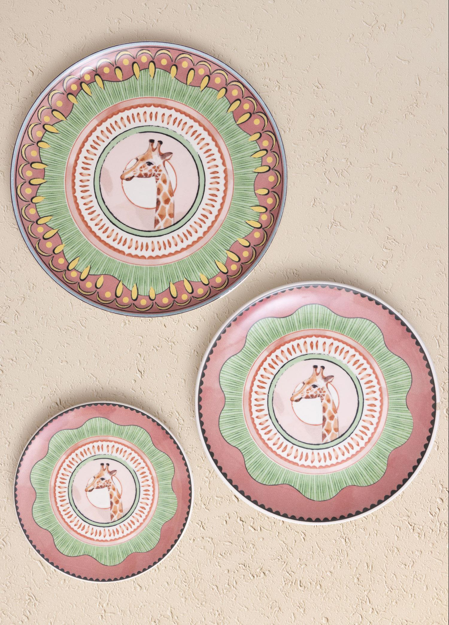 Zürafa motifli, yeşil, pembe ve sarı geometrik desenli üç tabak.