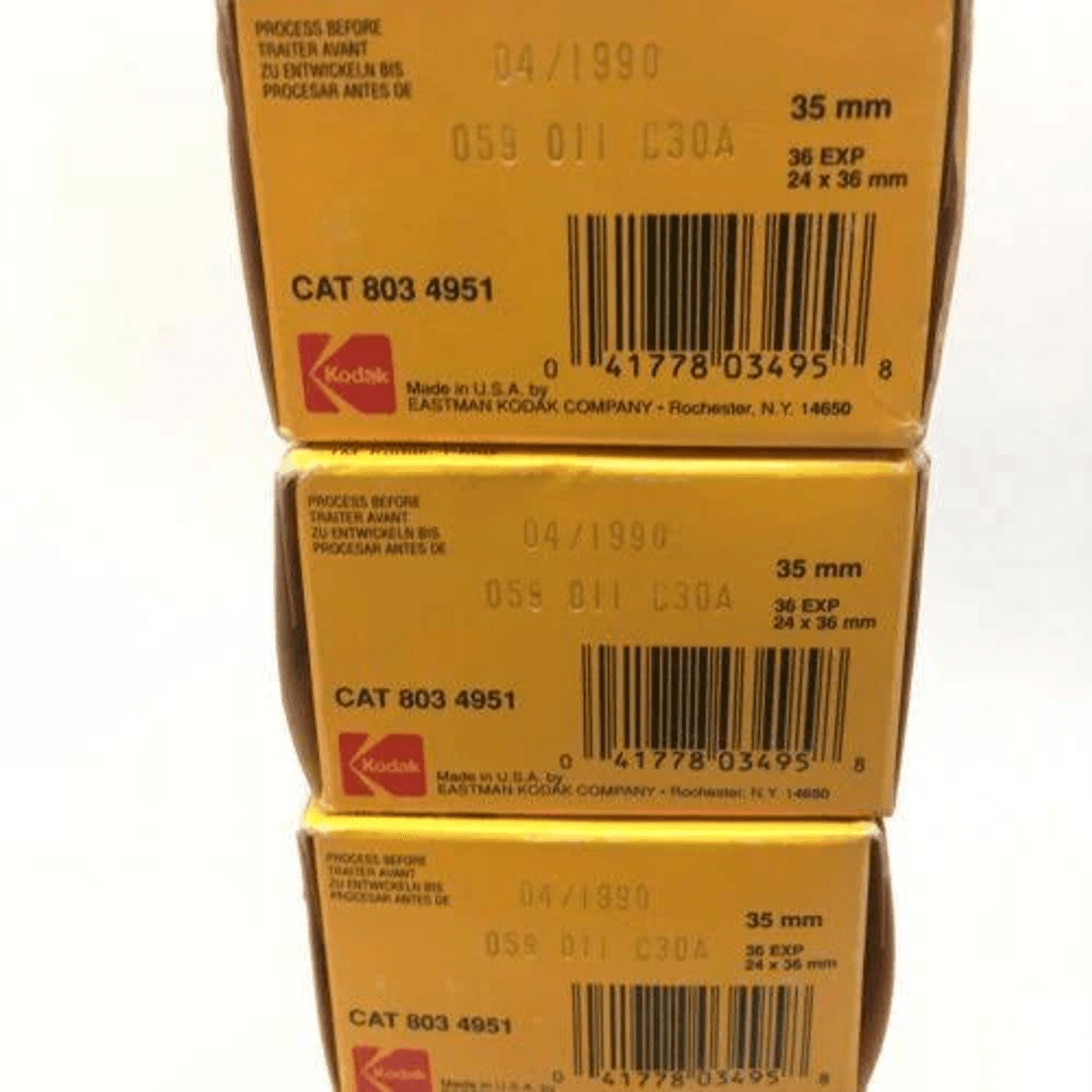 Tres cajas de película Kodak amarillas apiladas con códigos de barras y detalles de 35 mm.