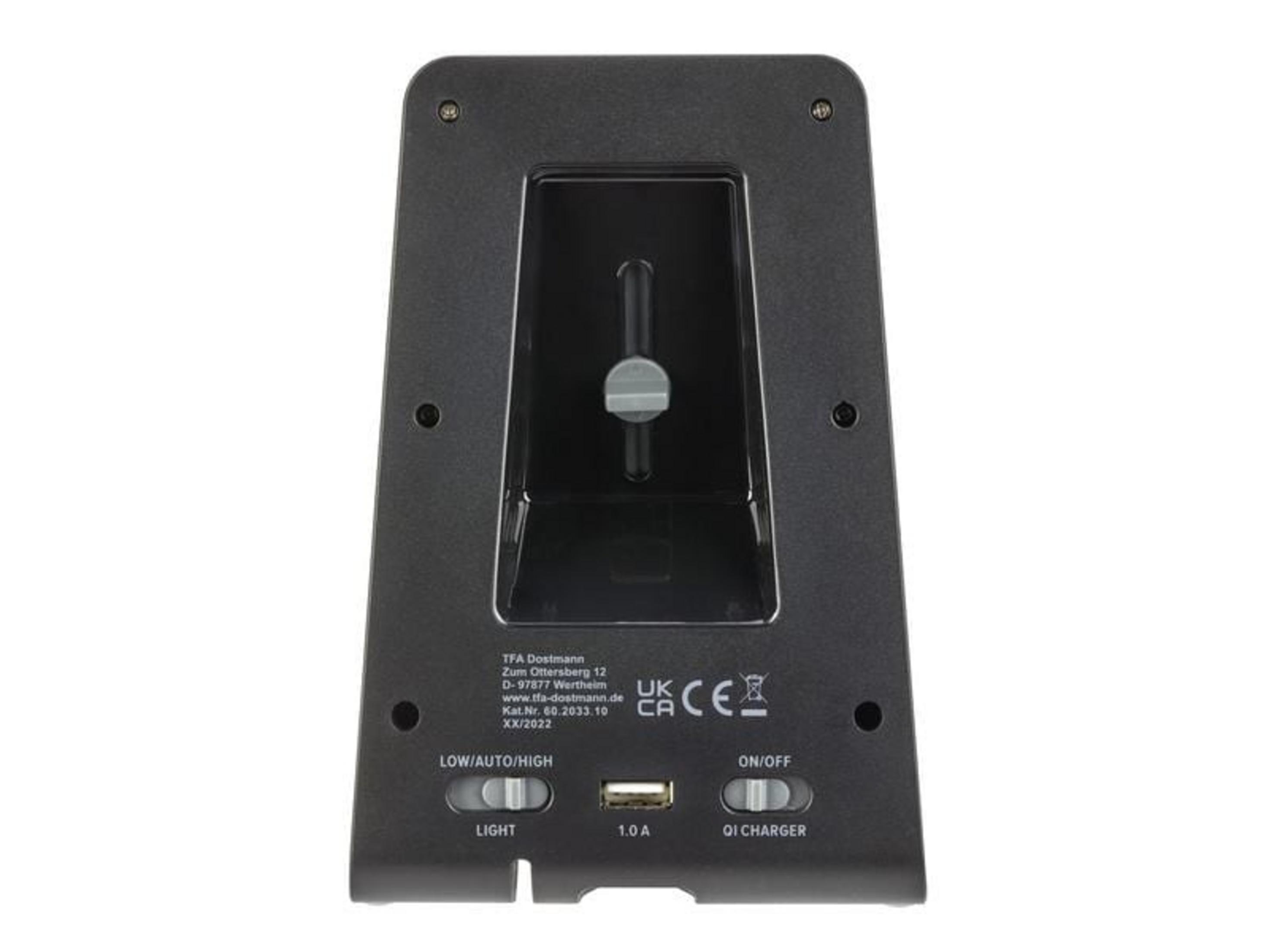 Schwarzes Qi-Ladegerät mit USB-Anschluss und Bedienelementen.