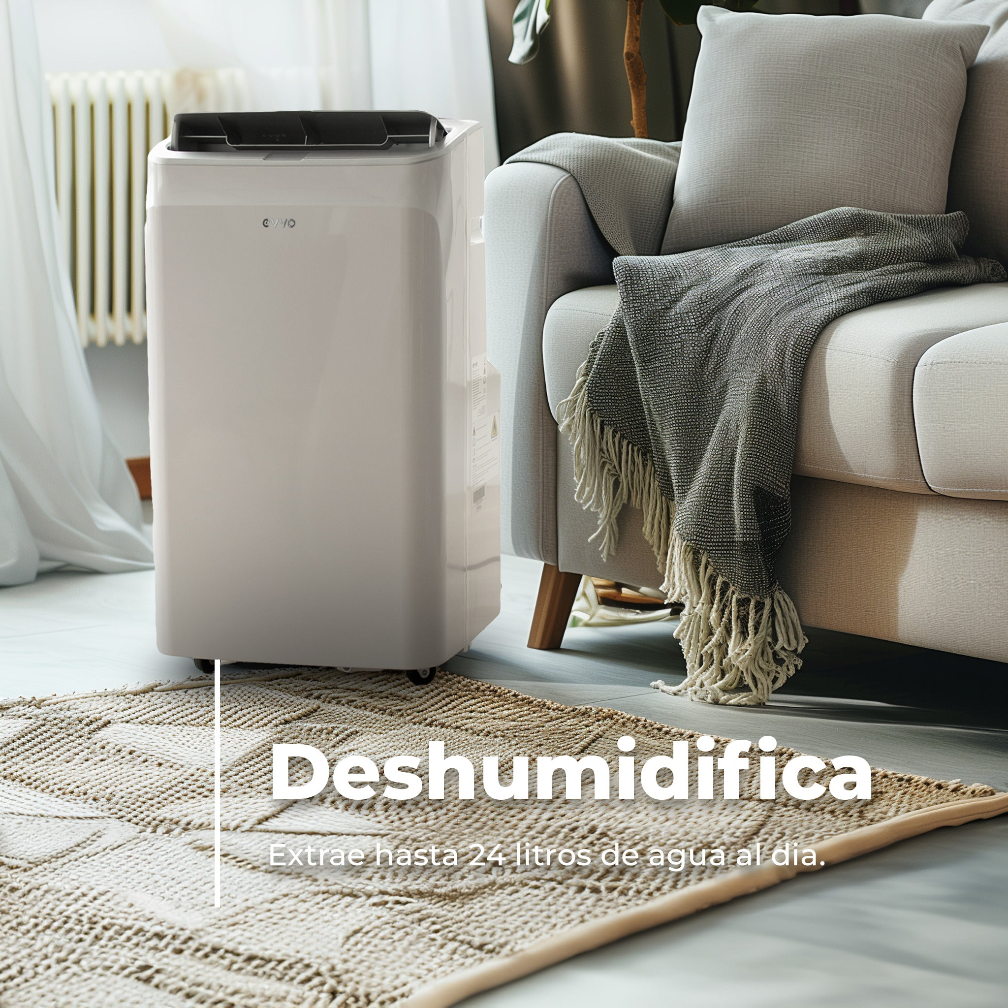 Un deshumidificador blanco junto a un sofá con manta.