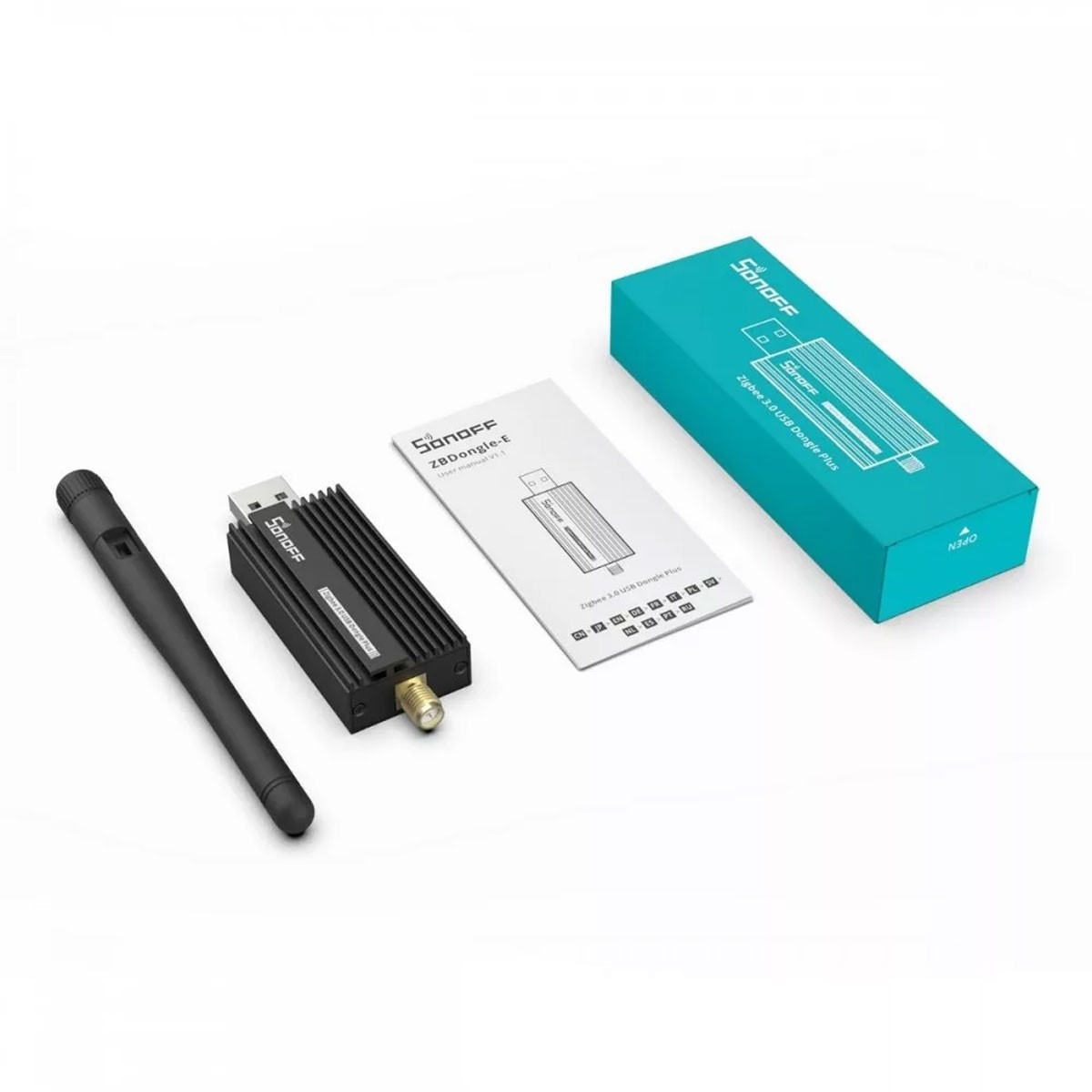 Ein schwarzer Zigbee-Dongle mit Antenne, Handbuch und blauer Verpackung.