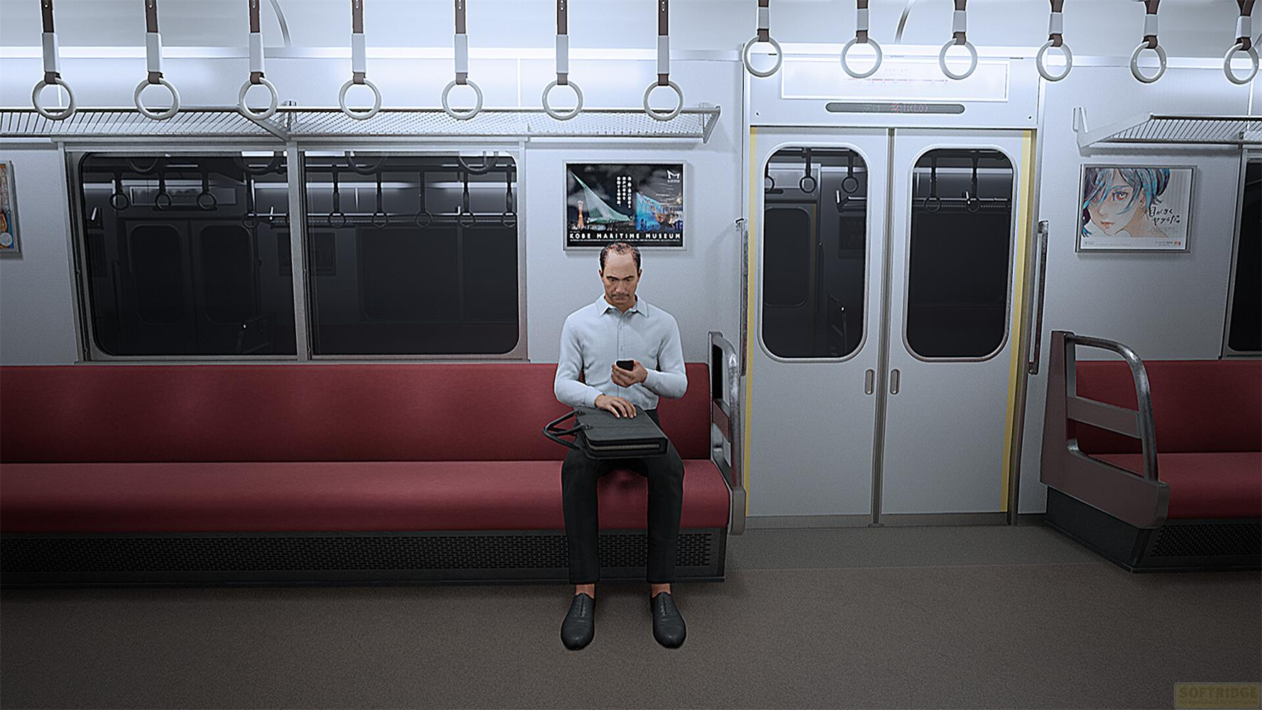 Un homme assis dans un wagon de train regarde son téléphone.