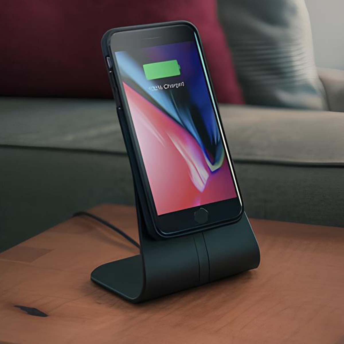 A black smartphone is placed on a black charging stand and is being charged.