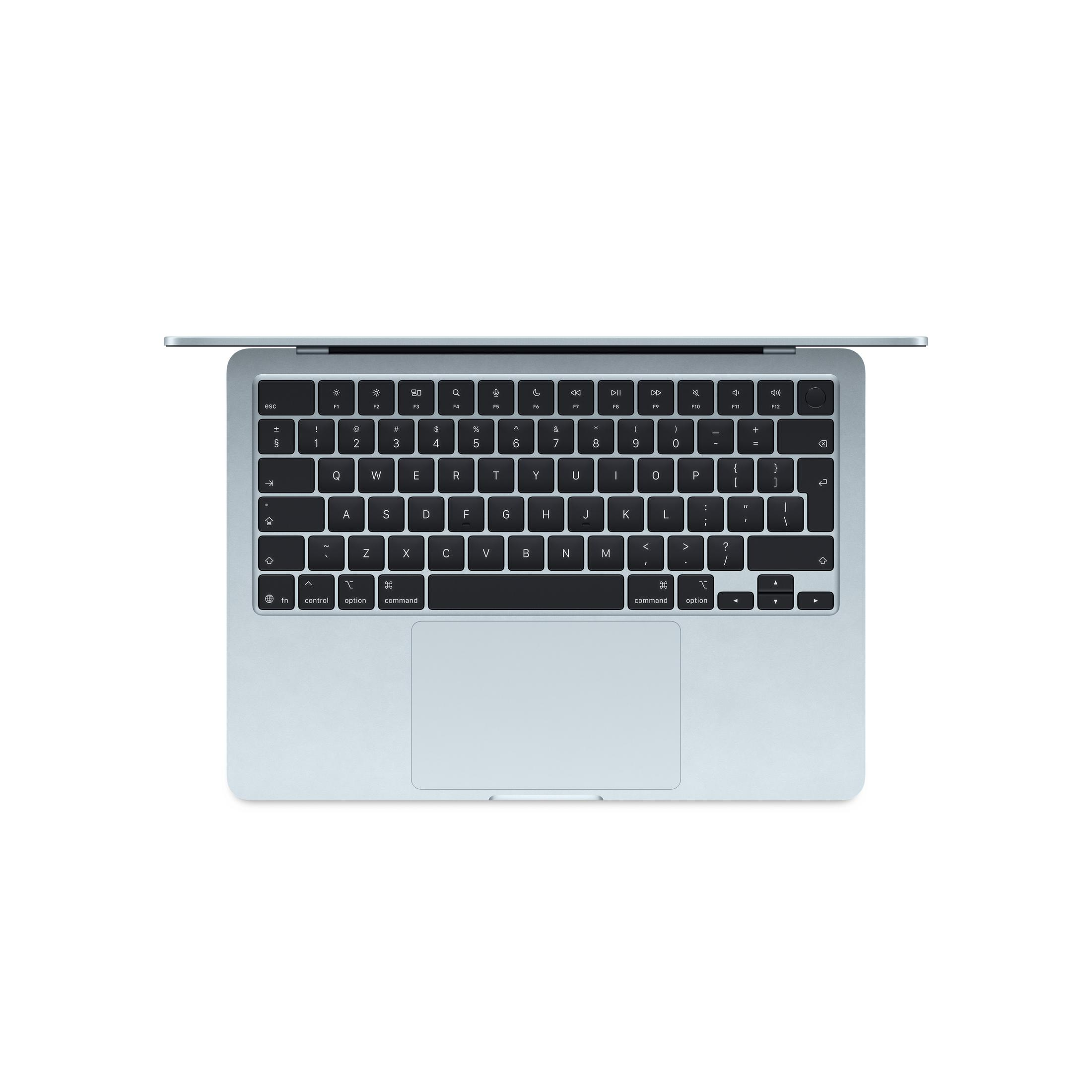 Un laptop argentato, visto dall'alto, mostra tastiera e trackpad illuminati.