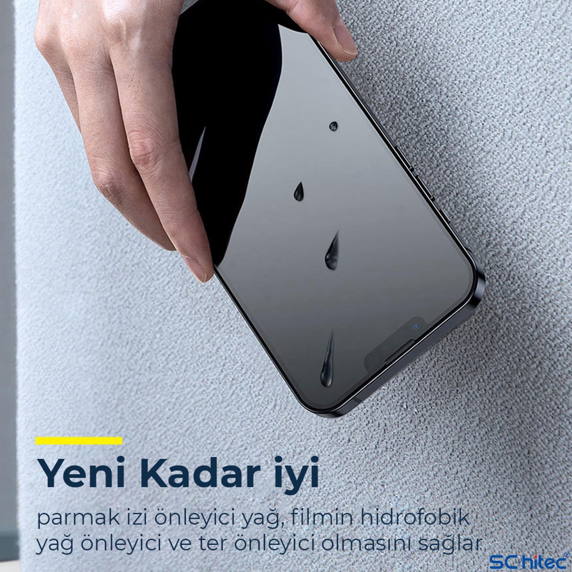 Bir el, ekranında su damlaları olan siyah bir akıllı telefon tutuyor.