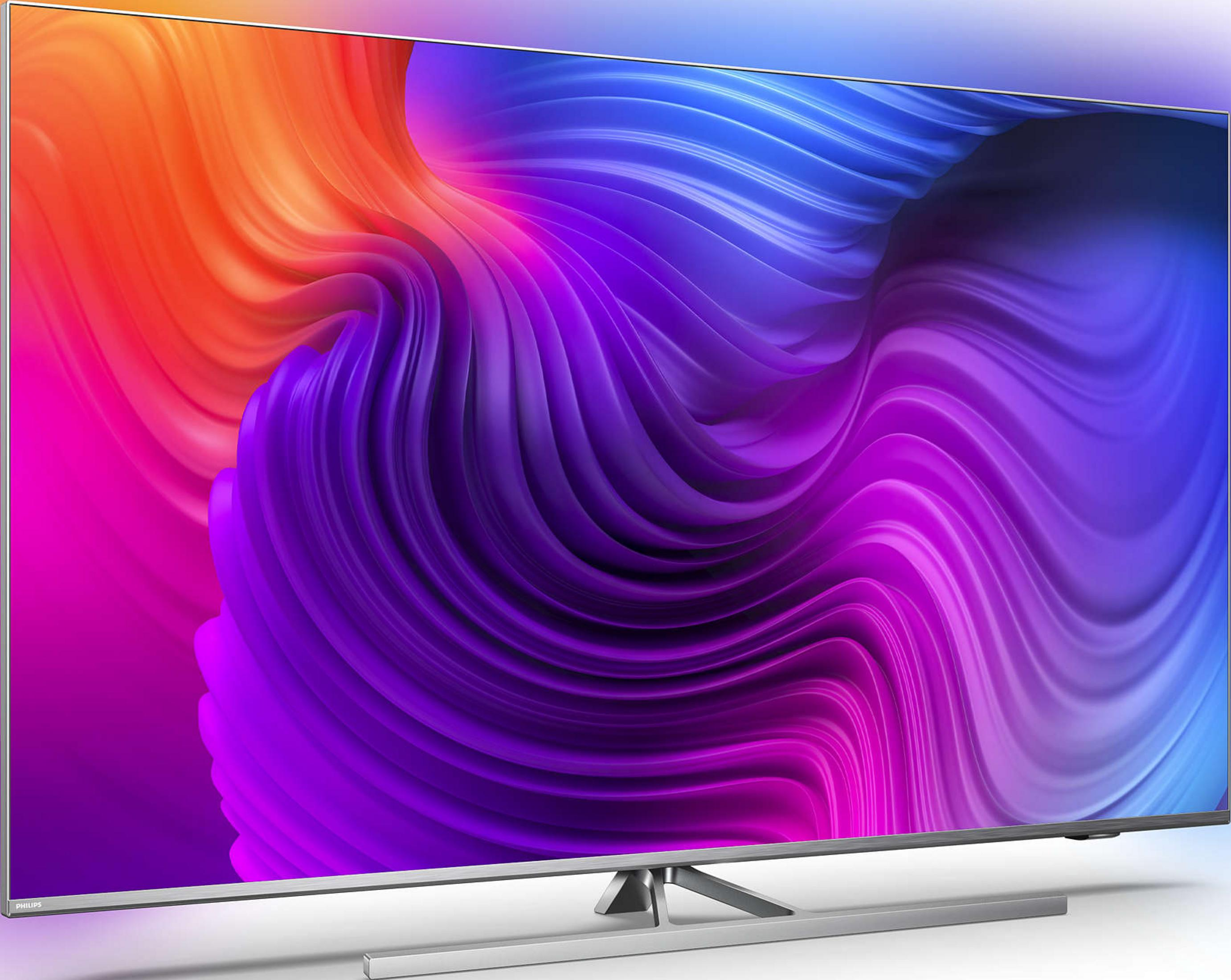 Een moderne flatscreen-tv met een abstracte, kleurrijke achtergrond.