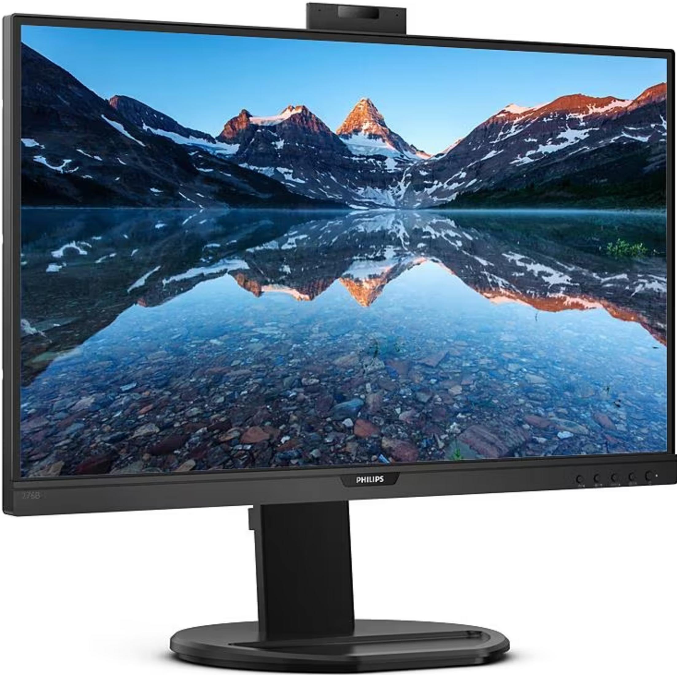 Un monitor muestra un paisaje montañoso con lago y reflejo.