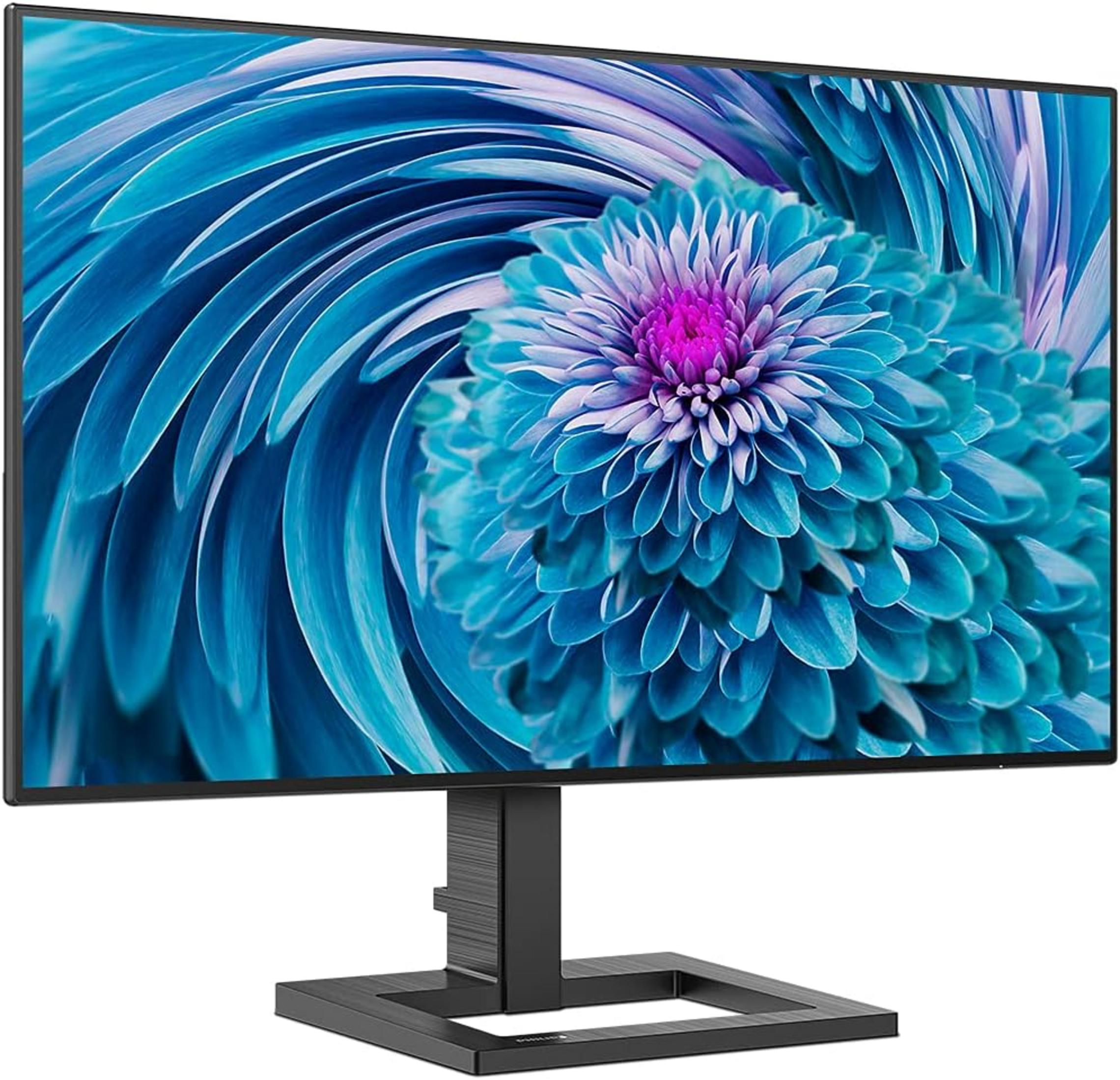 Un monitor con un motivo floreale blu sullo schermo e un supporto nero.