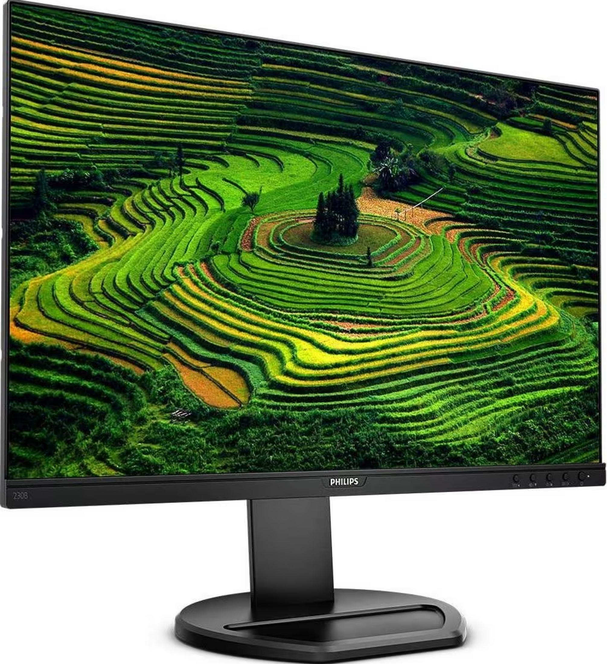 A black monitor displaying terraced green fields on its screen.