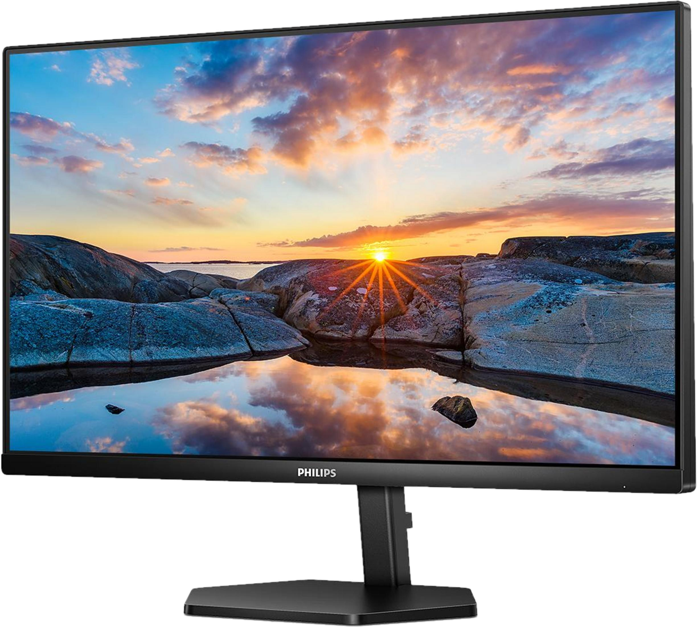 Un monitor Philips mostra una costa rocciosa al tramonto con riflessi sull'acqua.
