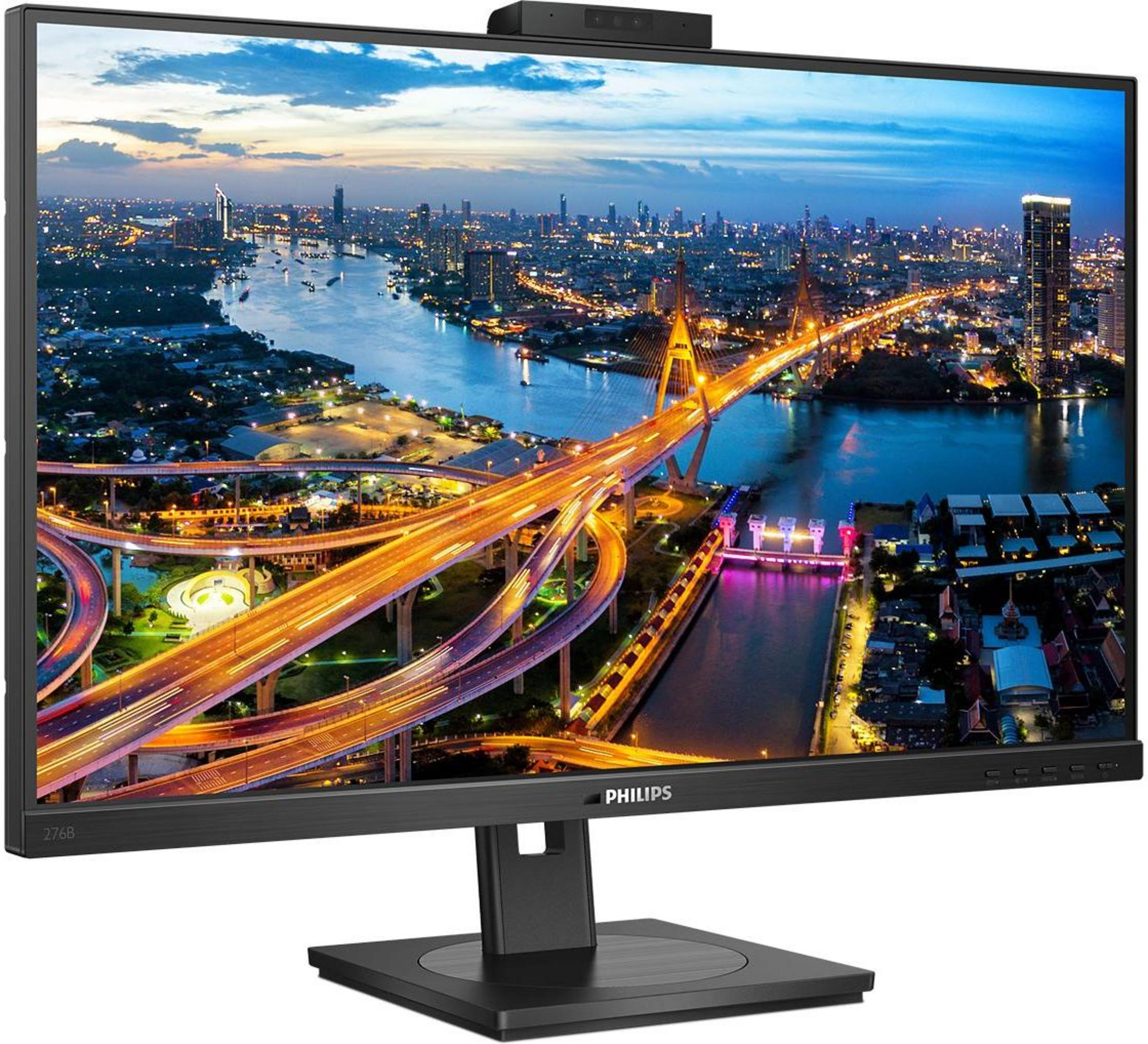 Nachtansicht einer Stadt mit beleuchteten Brücken und Fluss, auf einem Monitor gezeigt.
