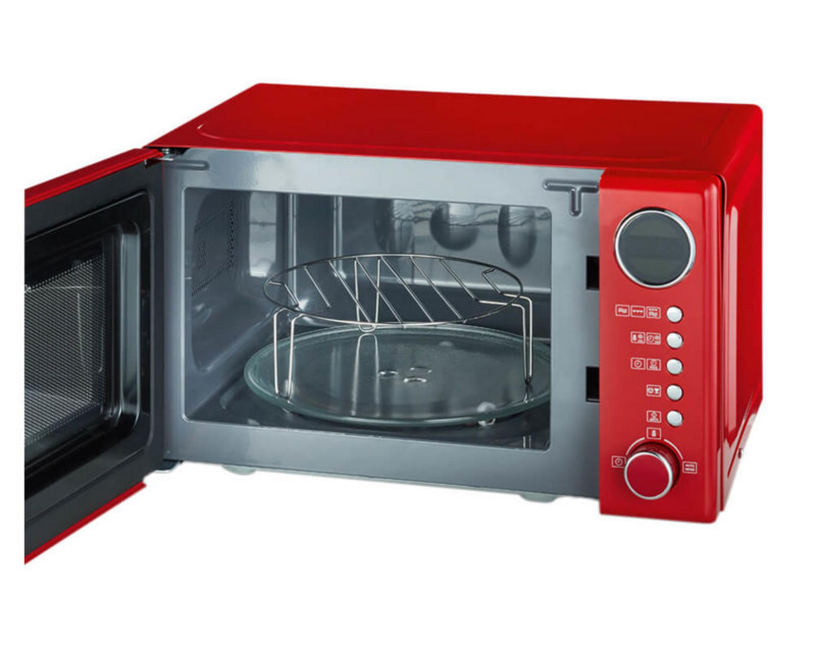 Un forno a microonde rosso con porta aperta, piatto girevole in vetro e griglia.