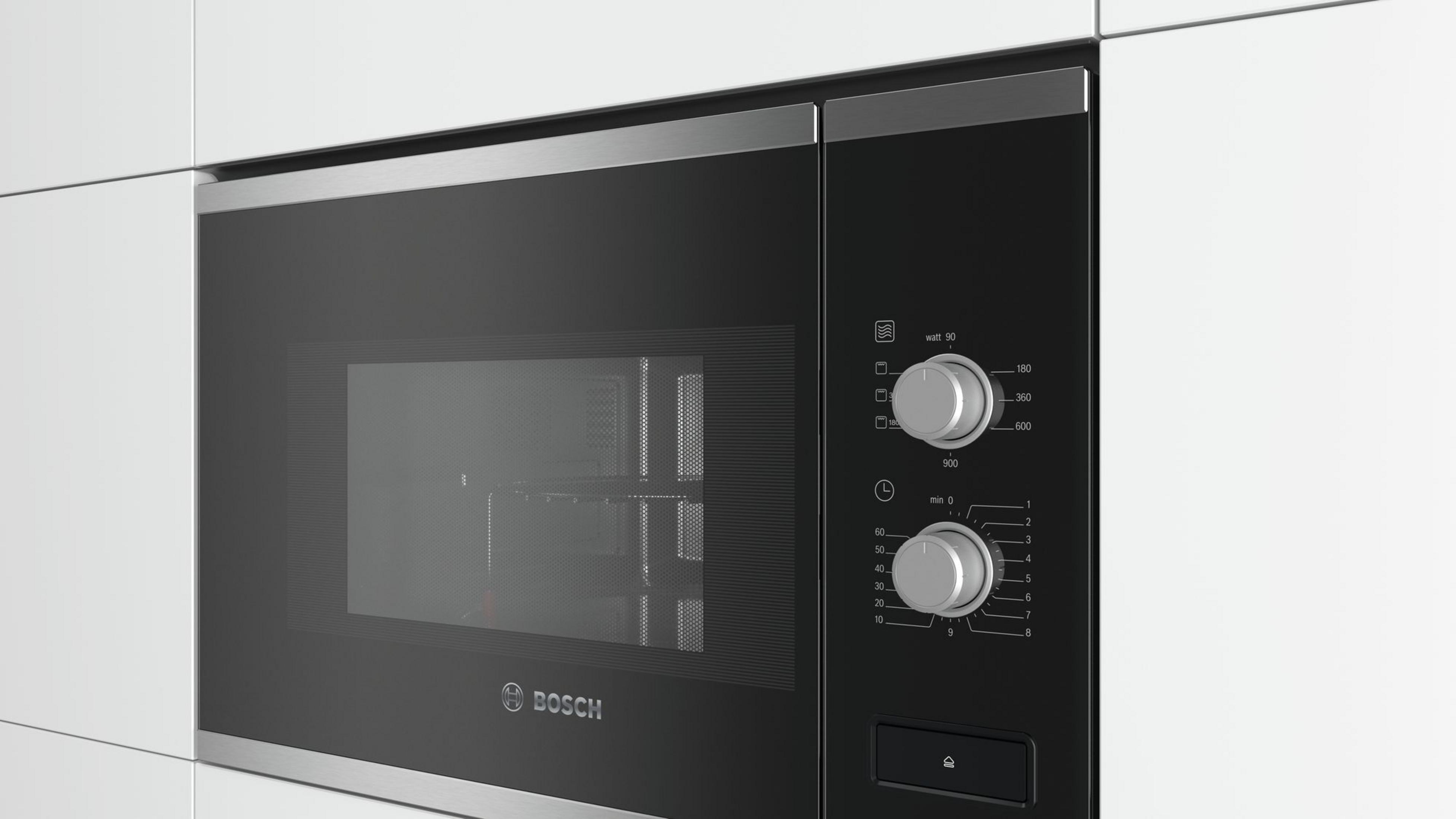 Un microondas empotrado Bosch negro moderno con diales plateados.