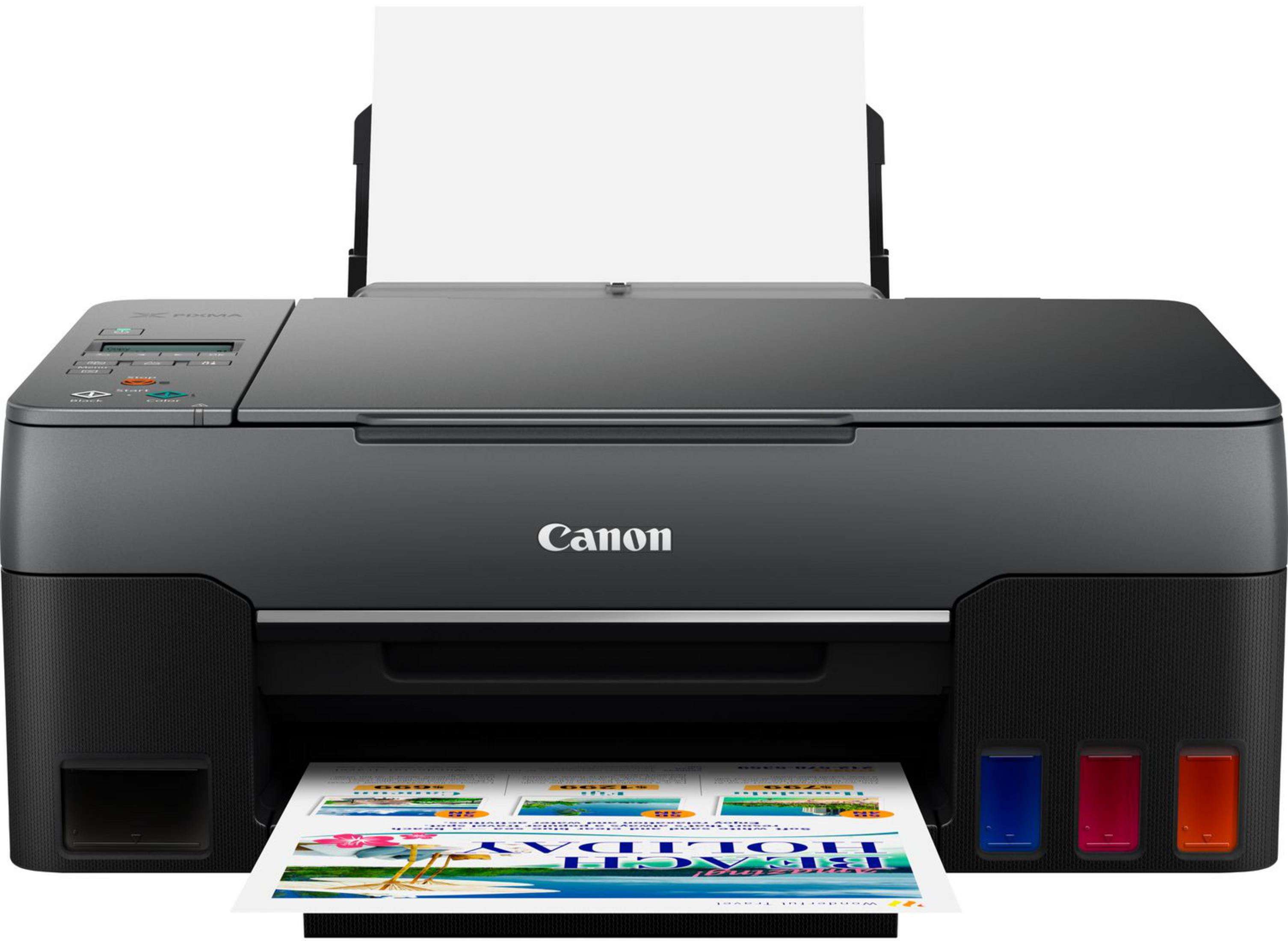 Una stampante Canon Pixma grigia con carta stampata e serbatoi d'inchiostro visibili.