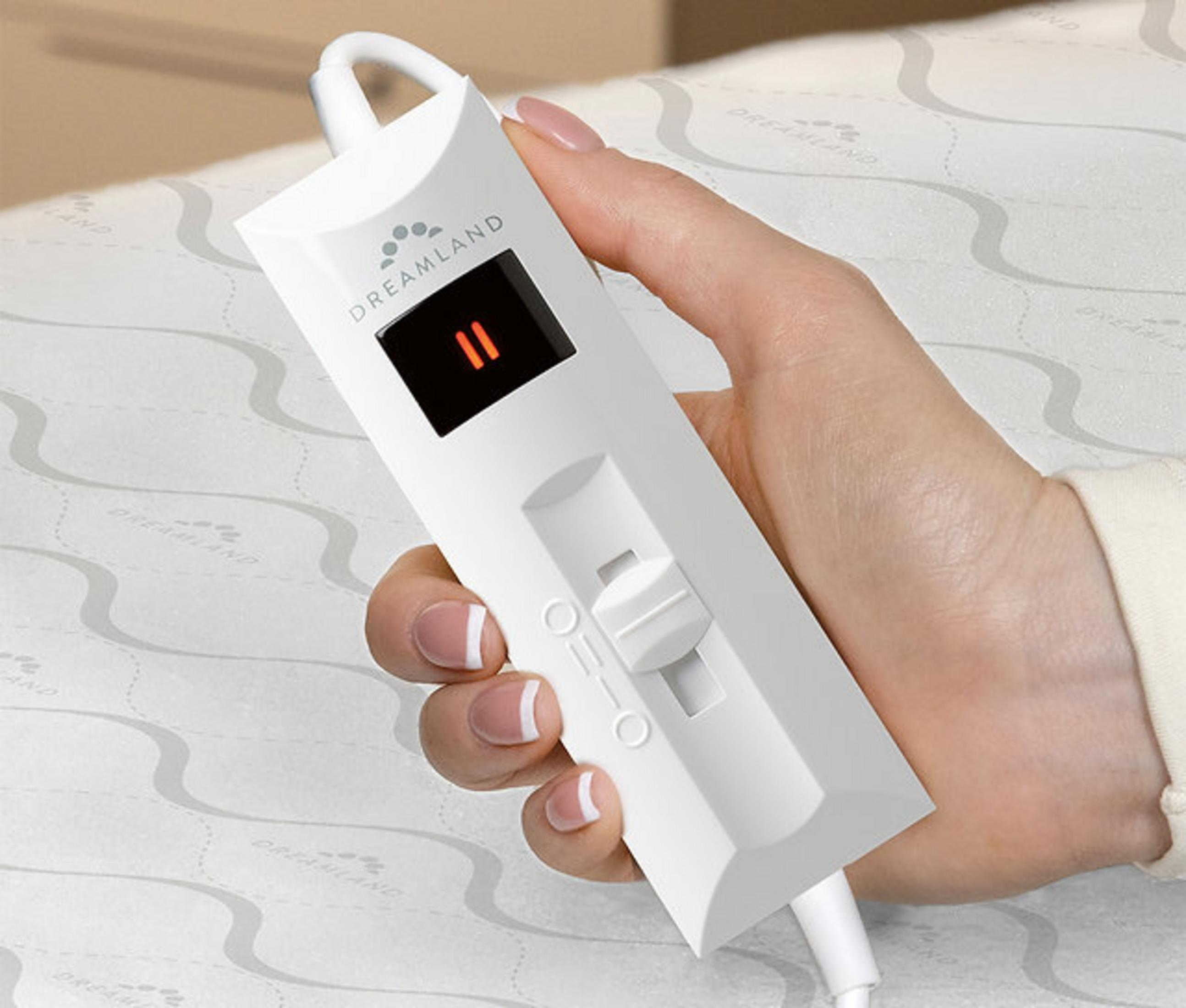 A hand holds a white remote with a black screen displaying '11'.